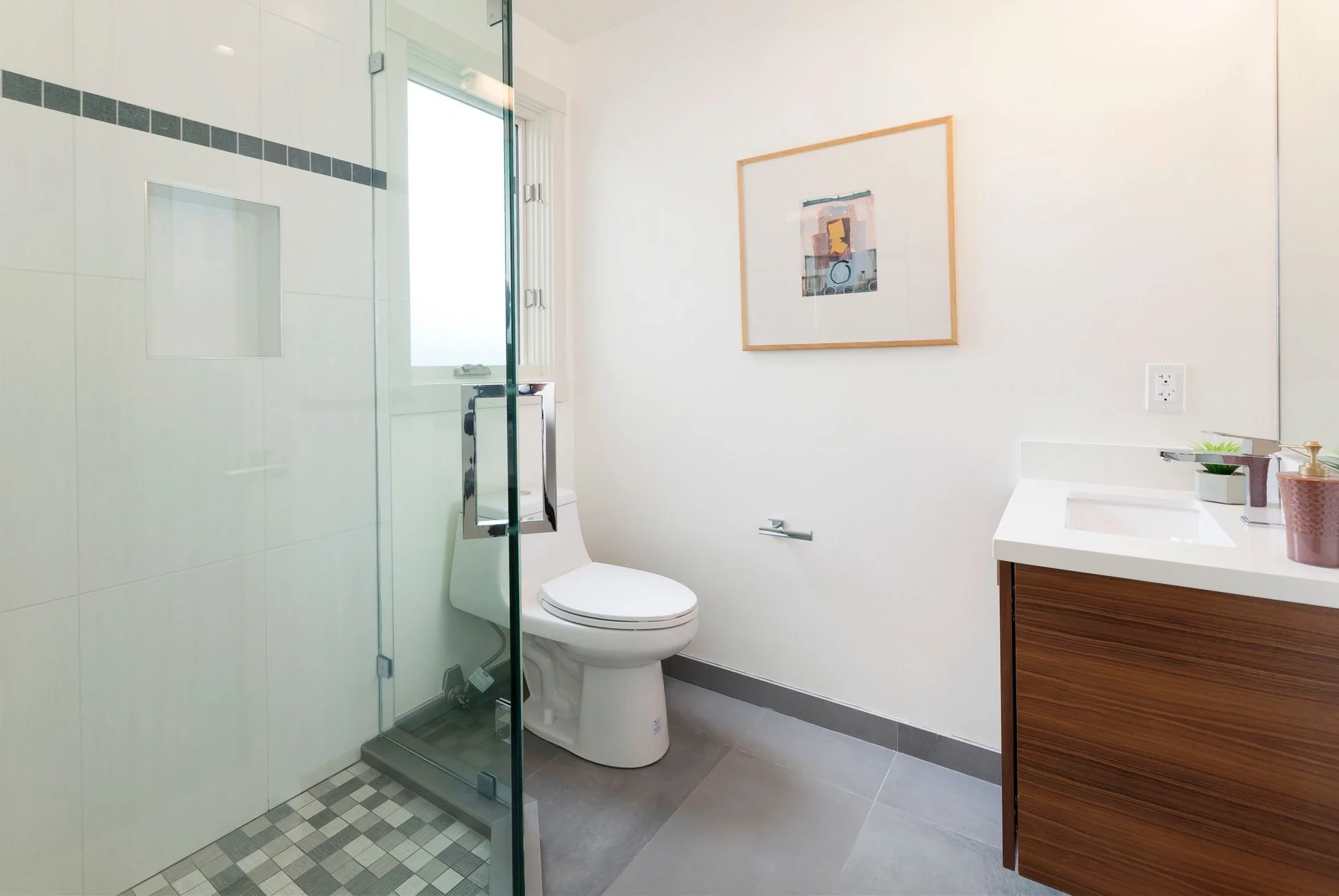 Condo bathroom remodel with glass shower enclosure and modern fixtures — San Francisco Bay Area general contractor