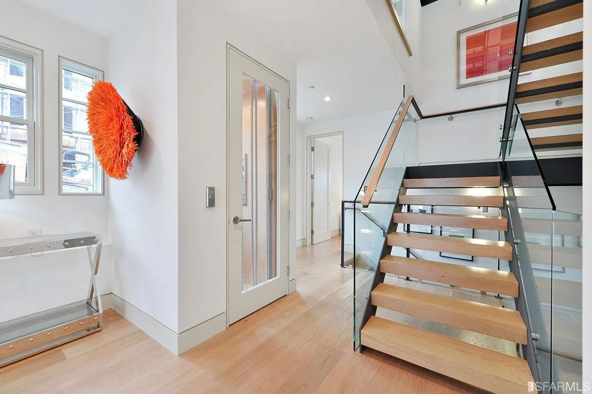 hallway with open stairs, recessed lighting, and hardwood floors — San Francisco Bay Area general contractor