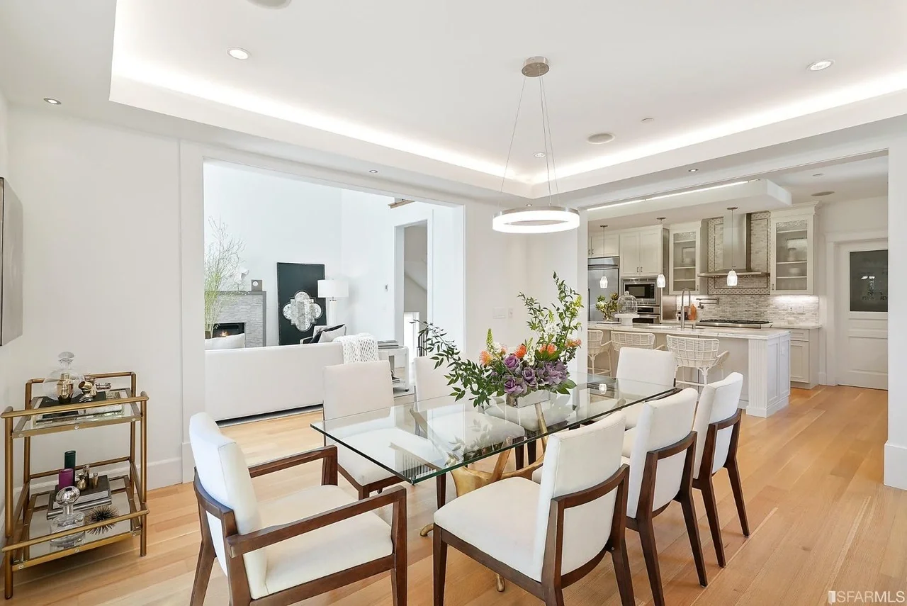 Open dining-to-kitchen layout with bright finishes, clean trim work, and updated lighting — San Francisco Bay Area general contractor.