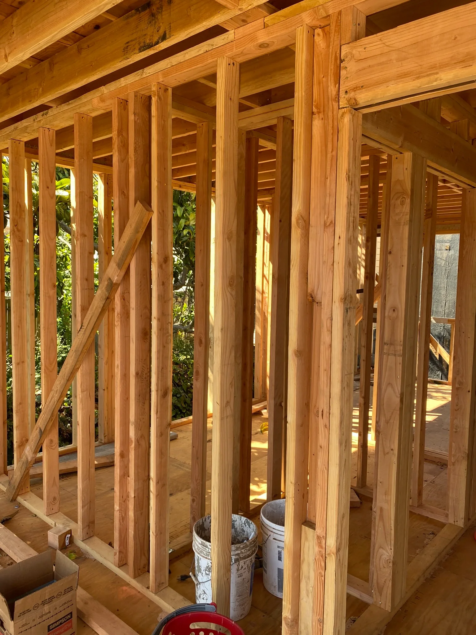 Two-story detached ADU framing in progress with stud walls and rough openings — San Francisco Bay Area general contractor