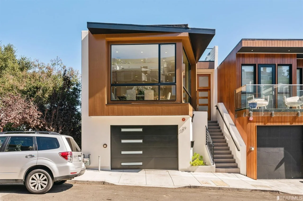 Modern exterior front elevation of single-family home addition with updated entry and siding — San Francisco Bay Area general contractor