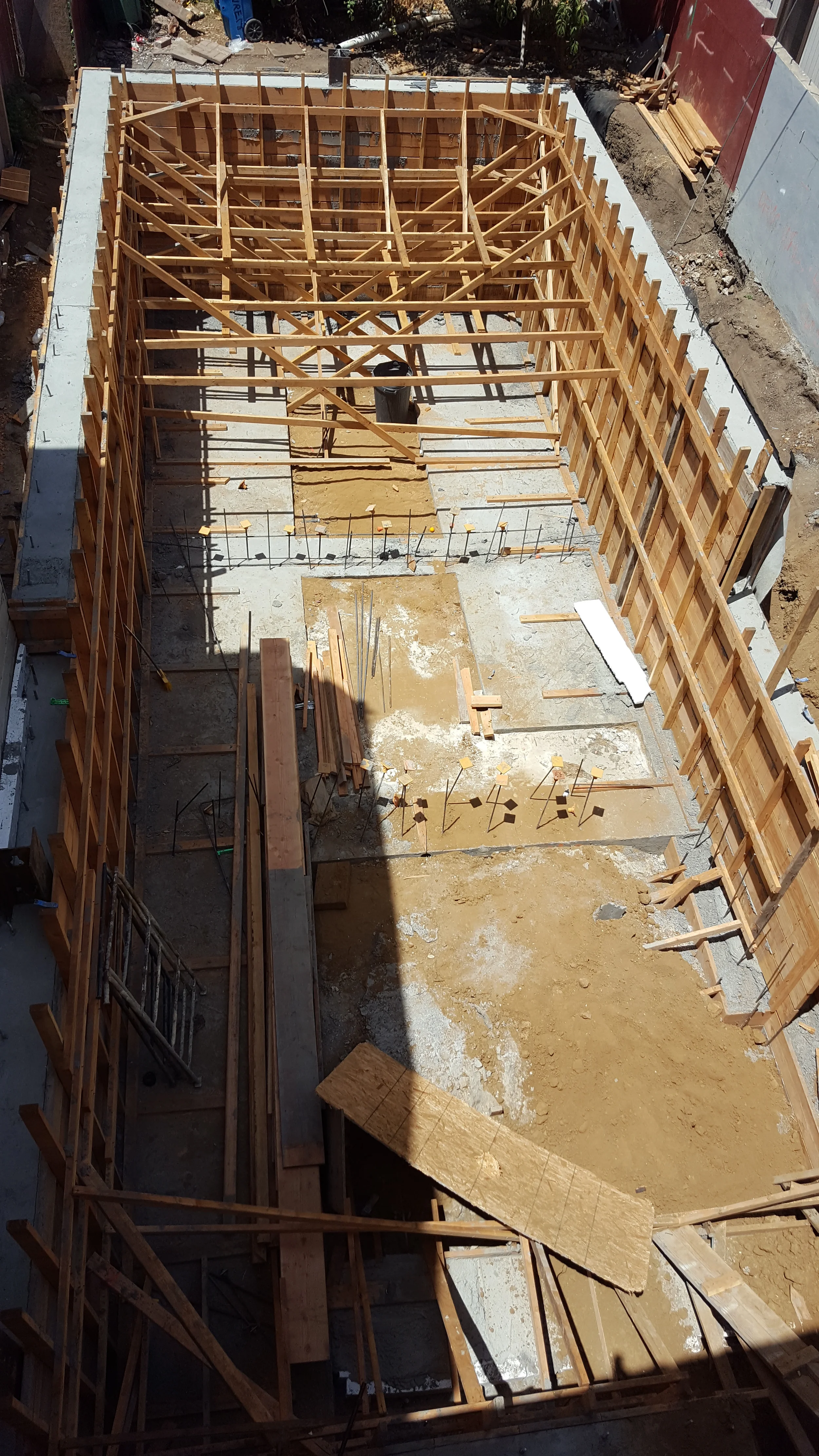 Footing trench with rebar reinforcement ready for concrete pour — San Francisco Bay Area general contractor