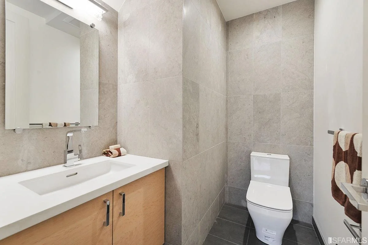 powder room with modern toilet and textured wall tile — San Francisco Bay Area general contractor