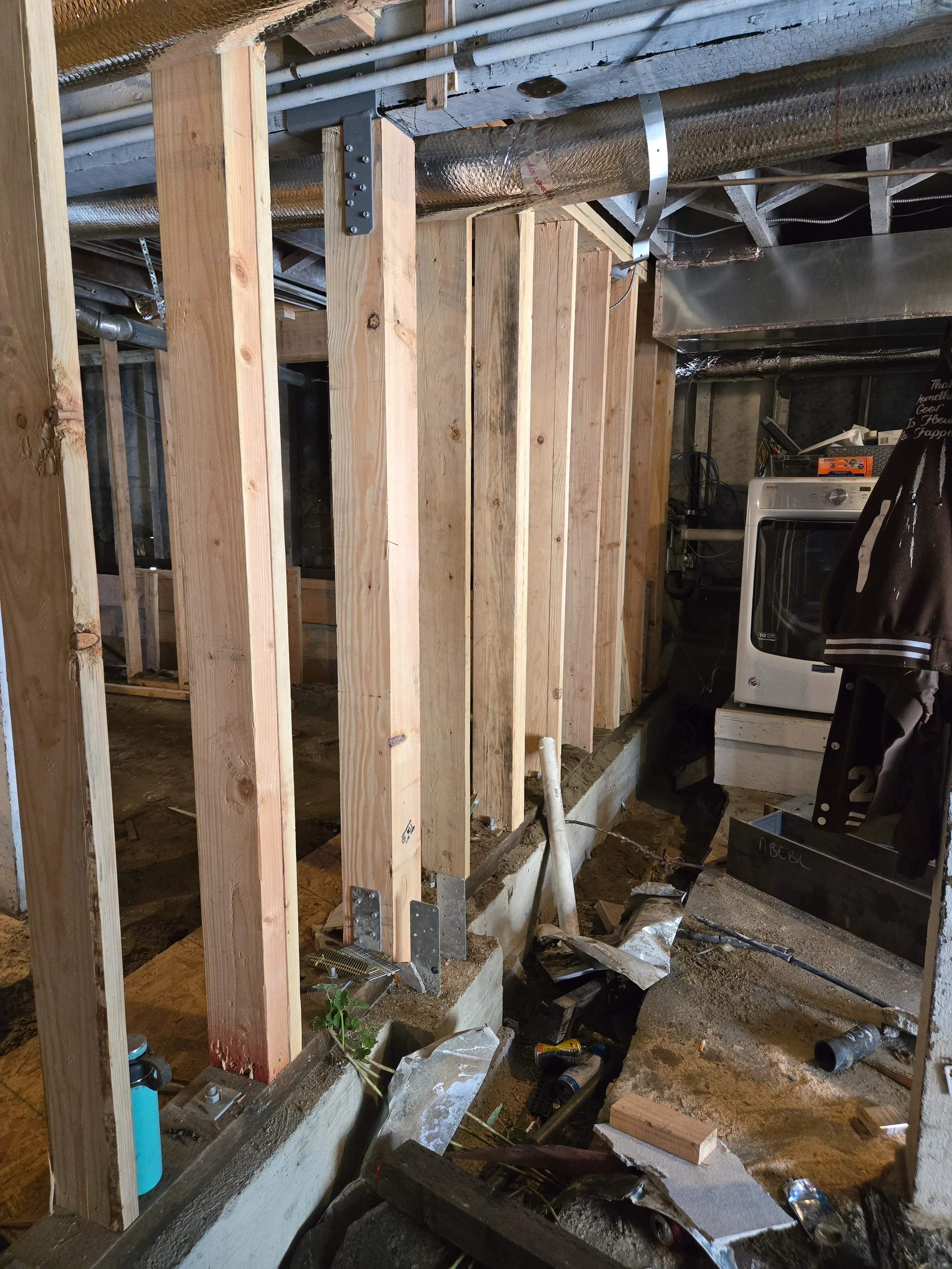 Interior rough framing around existing utilities during ground-floor conversion — San Francisco Bay Area general contractor
