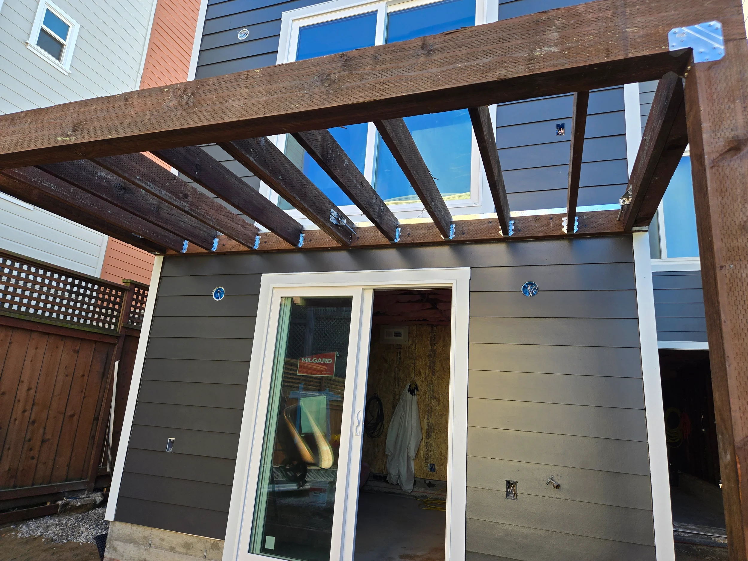 Sliding door install under deck framing as part of ground-floor conversion — San Francisco Bay Area general contractor