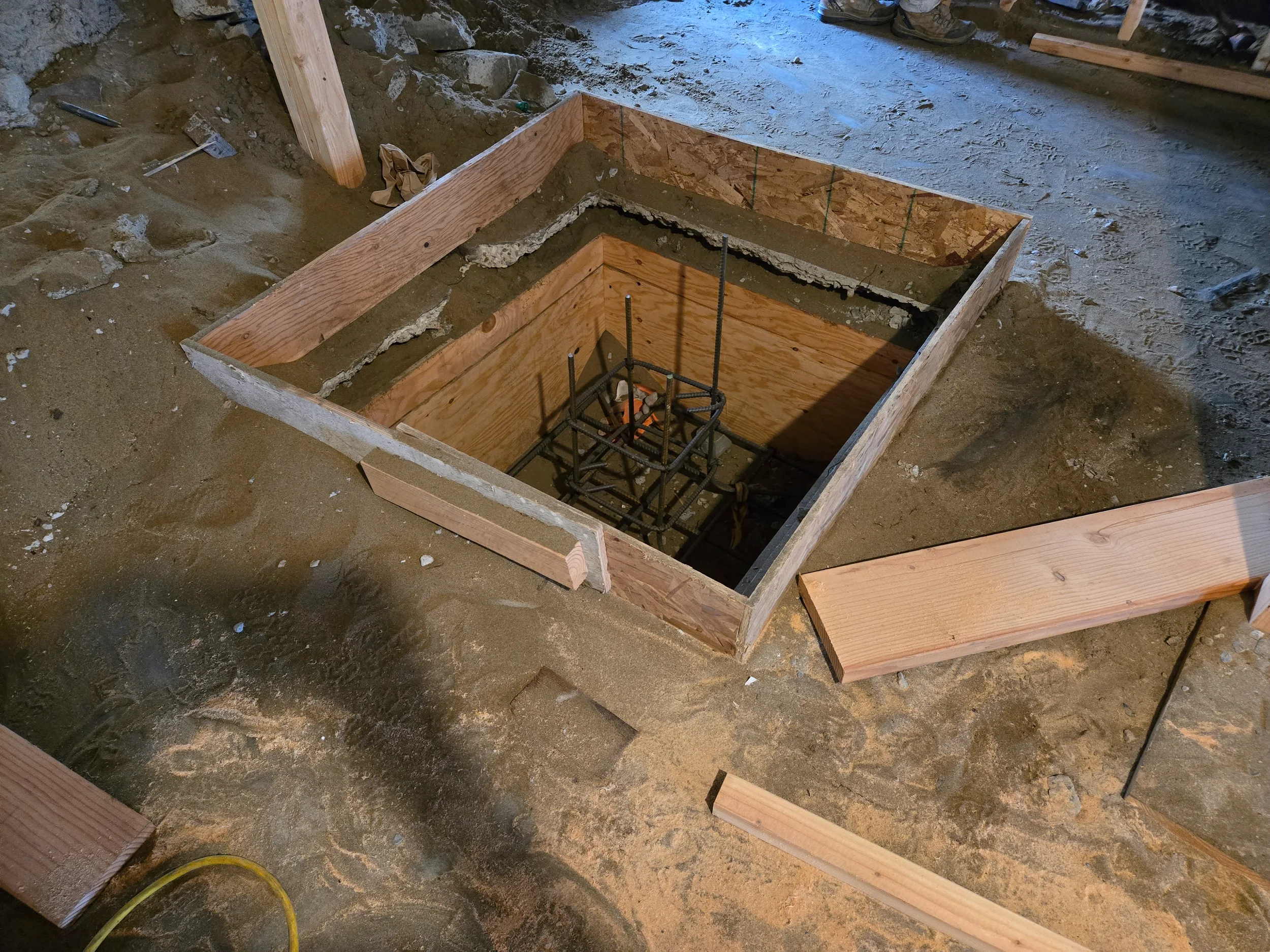 Excavation and formwork for new footing or light well during ground-floor conversion — San Francisco Bay Area general contractor