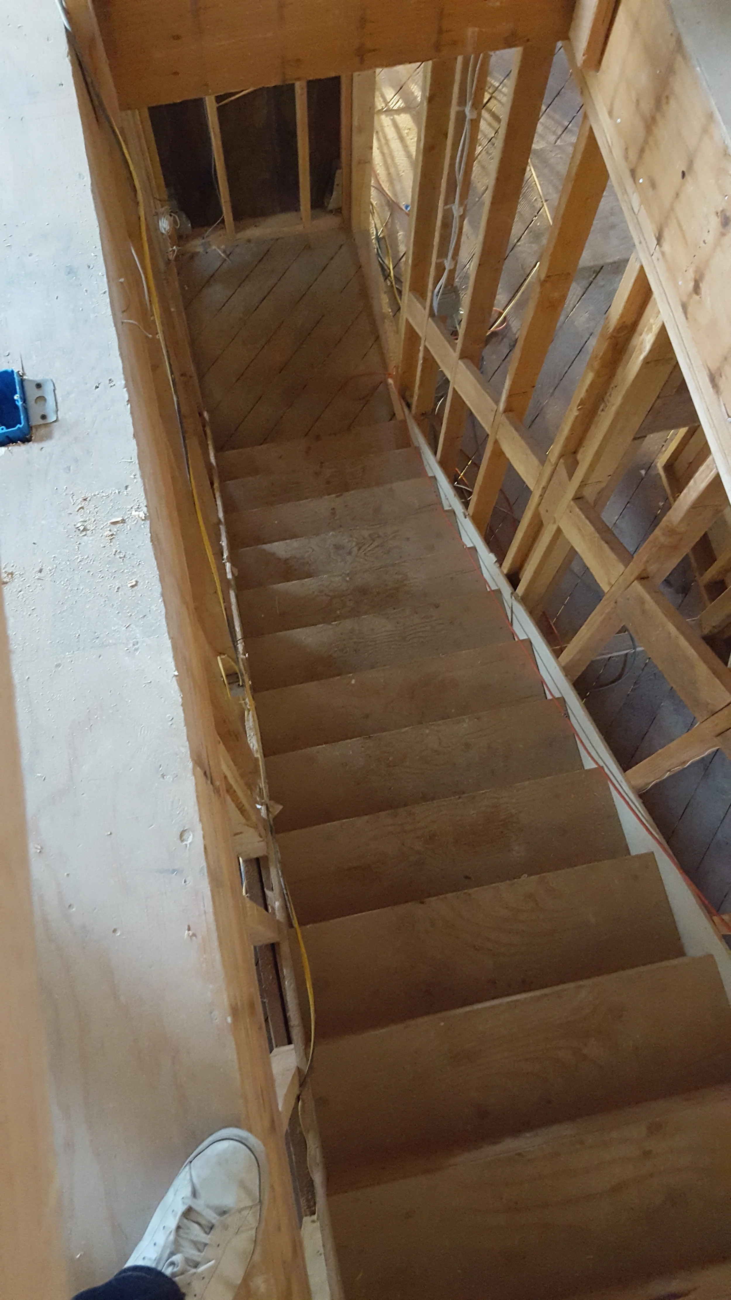 Stair framing detail with exposed joists during condo renovation — San Francisco Bay Area general contractor