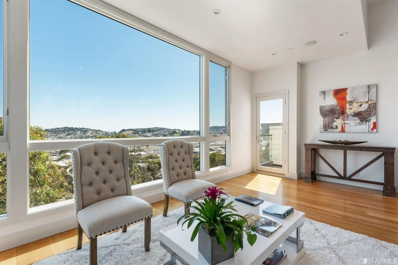 Sunlit sitting area in home addition with corner windows and Bay Area view — San Francisco Bay Area general contractor
