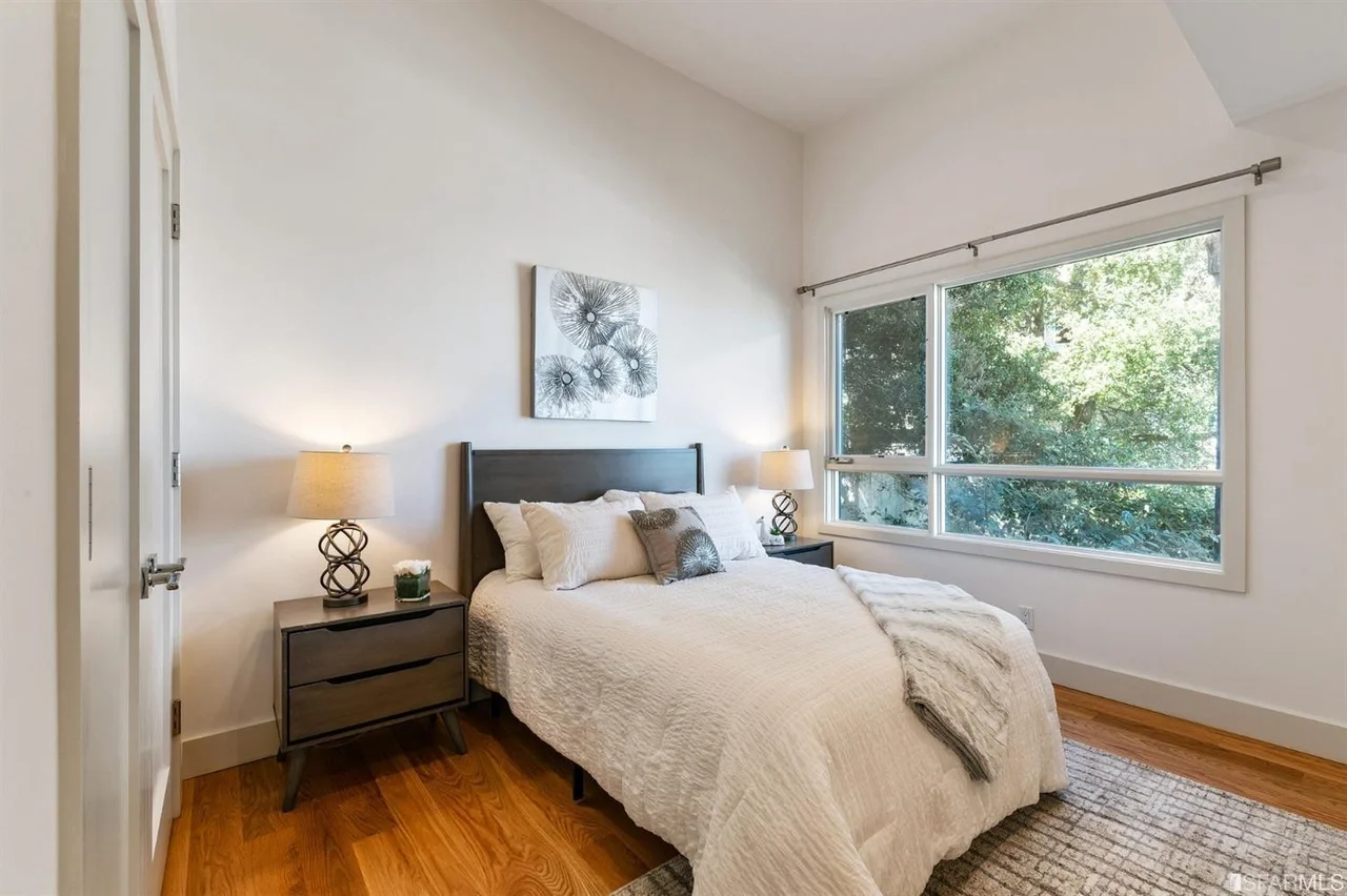 Guest bedroom addition with wide window and hardwood floors — San Francisco Bay Area general contractor