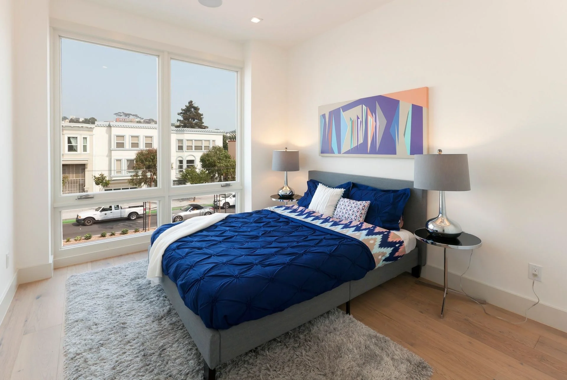 Bedroom in San Francisco Bay Area condo renovation with oversized windows and updated flooring — general contractor