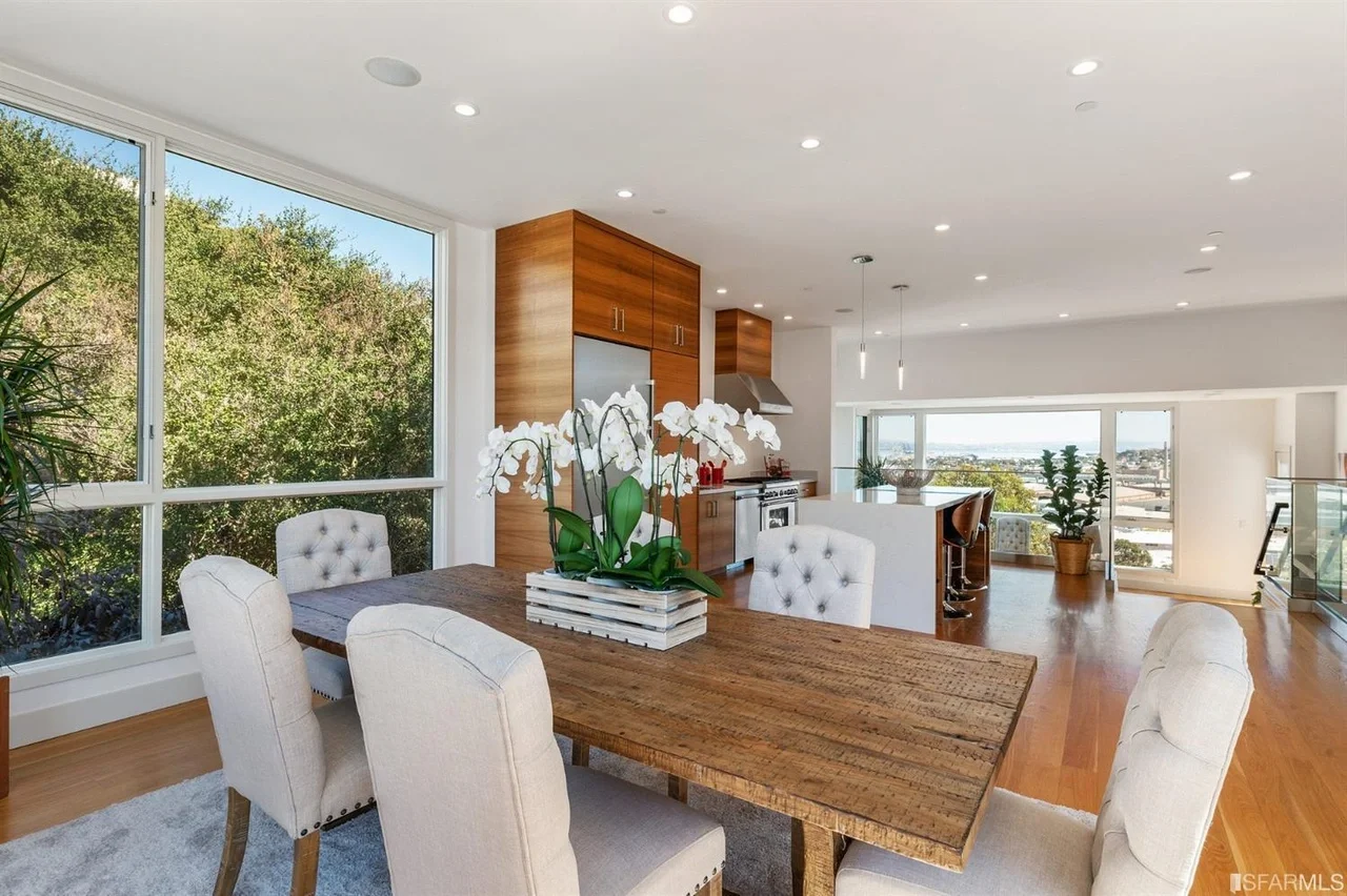 Open dining space with large windows and balcony access in home addition — San Francisco Bay Area general contractor