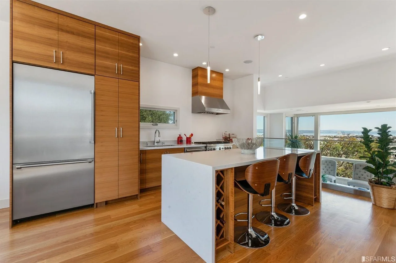 Kitchen island remodel in home addition with pendant lights and bar seating — San Francisco Bay Area general contractor