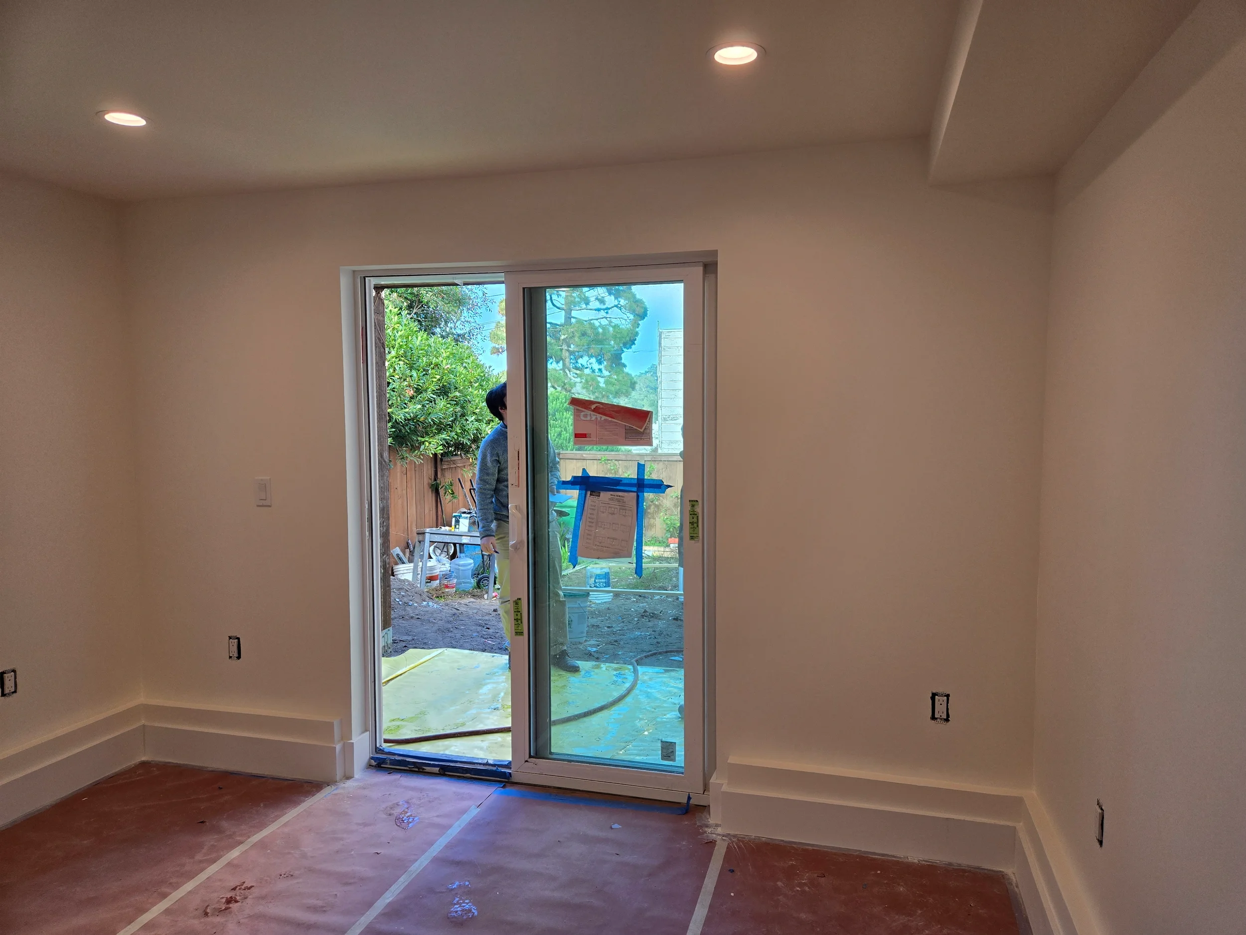 Finished drywall room with new exterior door access as part of ground-floor conversion — San Francisco Bay Area general contractor