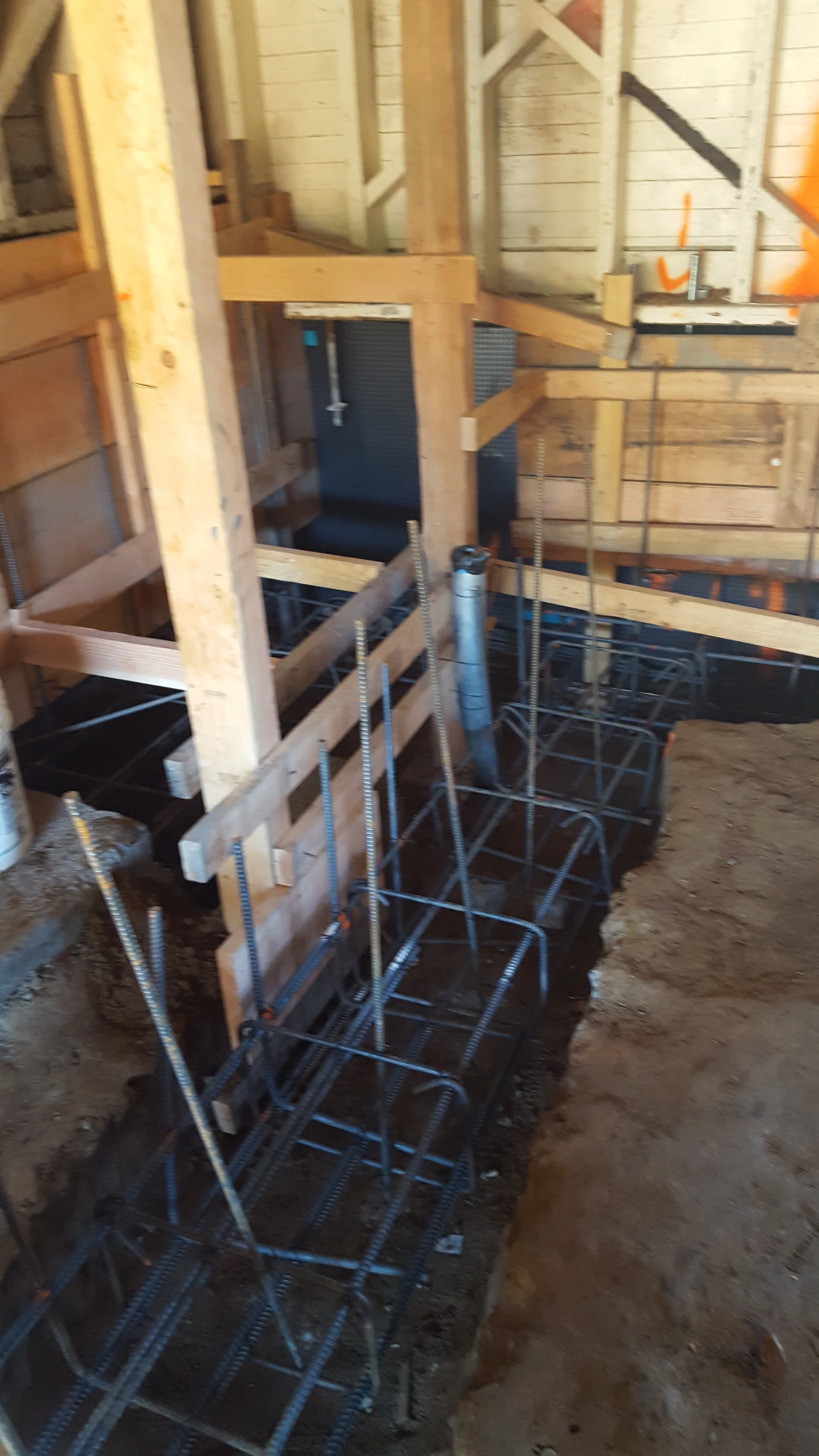 Interior foundation prep with rebar and formwork during condo renovation — San Francisco Bay Area general contractor