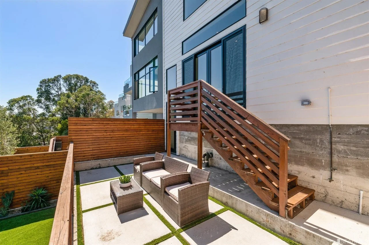 Exterior stairs and landing built for home addition with new wood railing — San Francisco Bay Area general contractor
