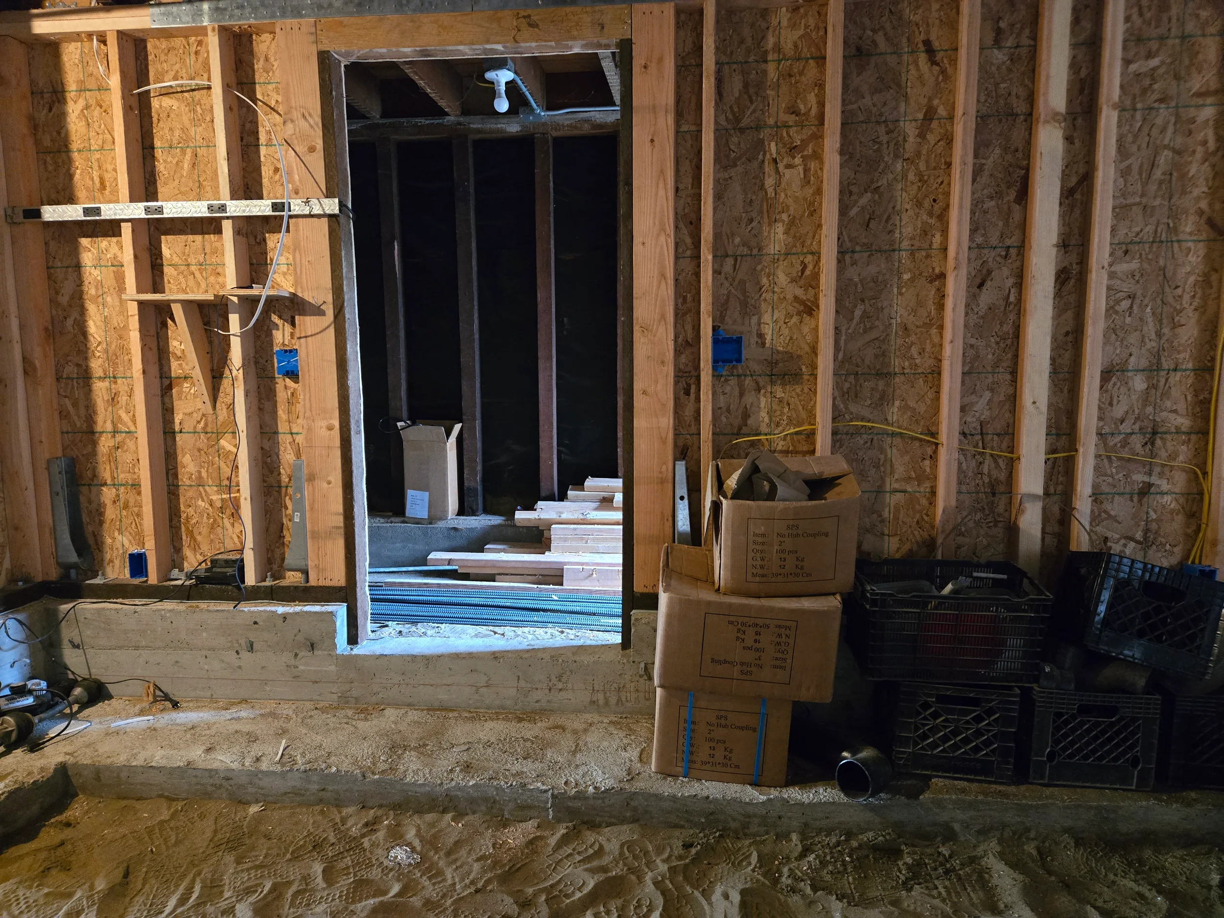 Crawlspace access area during ground-floor conversion with exposed framing — San Francisco Bay Area general contractor