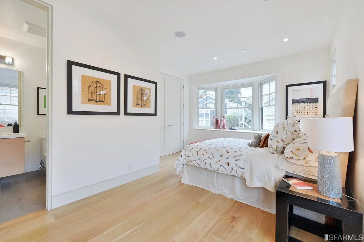bedroom with clean white walls and wide-plank hardwood flooring — San Francisco Bay Area general contractor