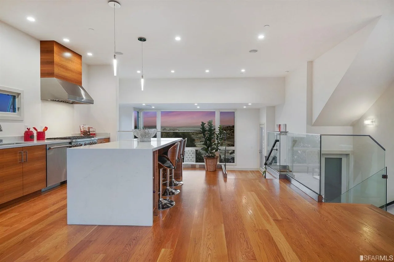 Open-plan kitchen and living area in home addition with hardwood floors — San Francisco Bay Area general contractor