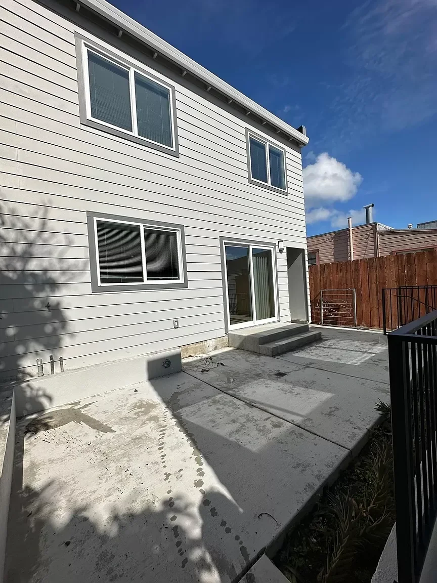 Detached ADU patio area with modern siding and privacy fencing — San Francisco Bay Area general contractor