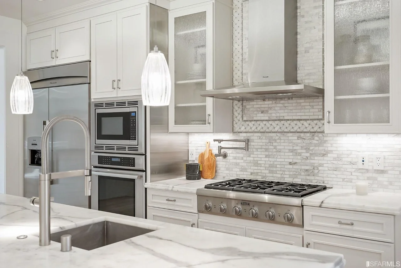 Open kitchen with large island, pendant lighting, and bar seating — San Francisco Bay Area general contractor