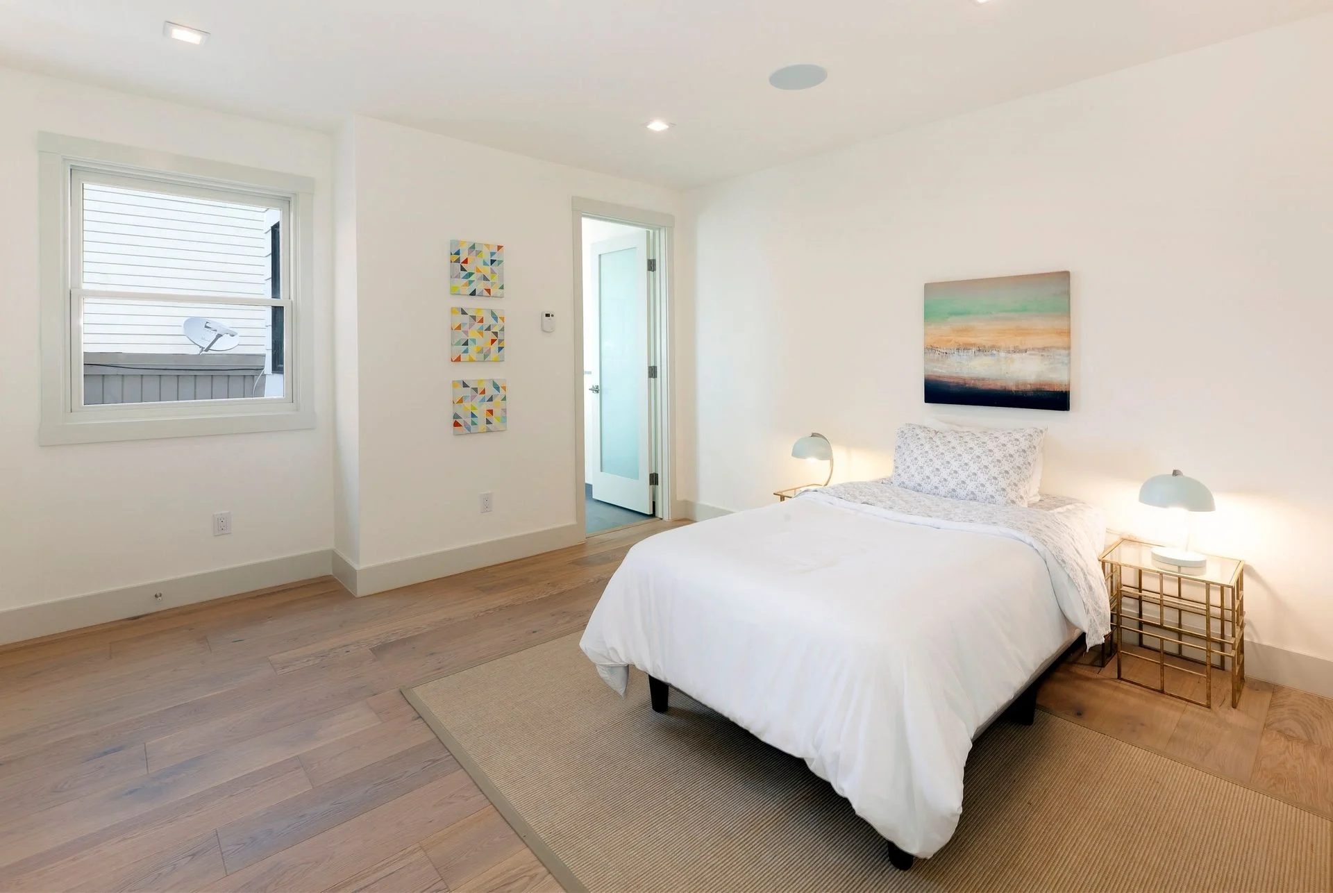 Condo bedroom renovation with large windows and refreshed finishes — San Francisco Bay Area general contractor