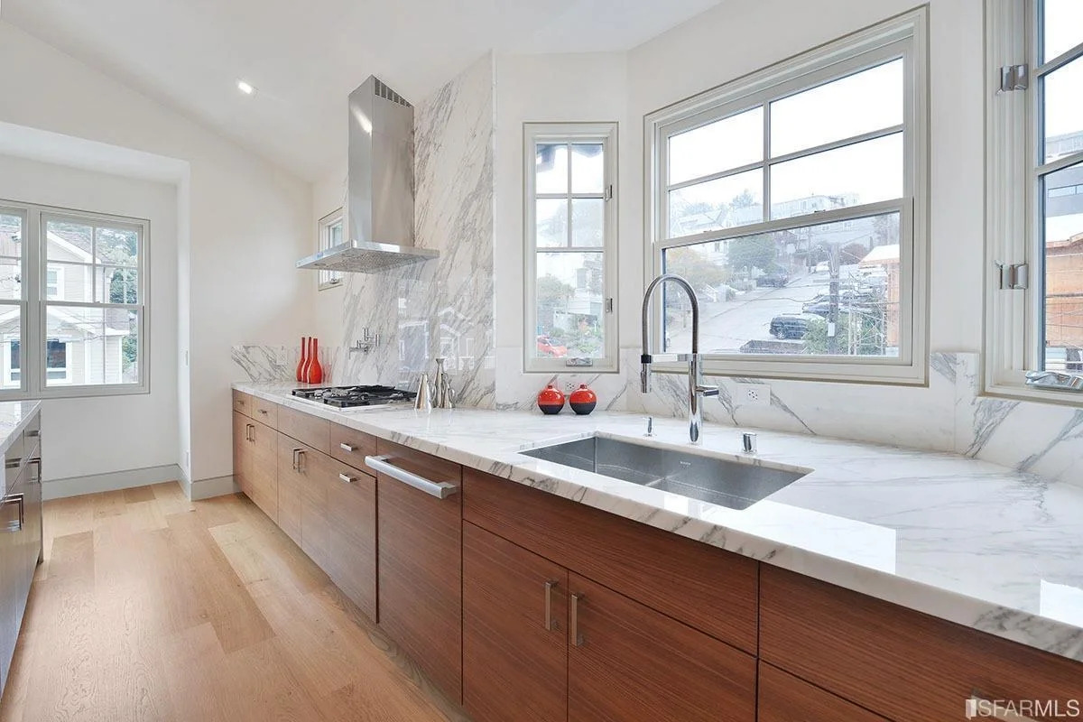 built-in cabinetry with stone countertop and large window light — San Francisco Bay Area general contractor