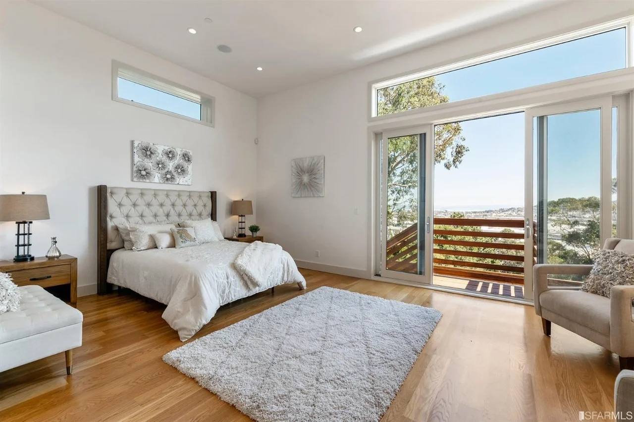 Bedroom addition with balcony door, high ceilings, and hardwood floors — San Francisco Bay Area general contractor
