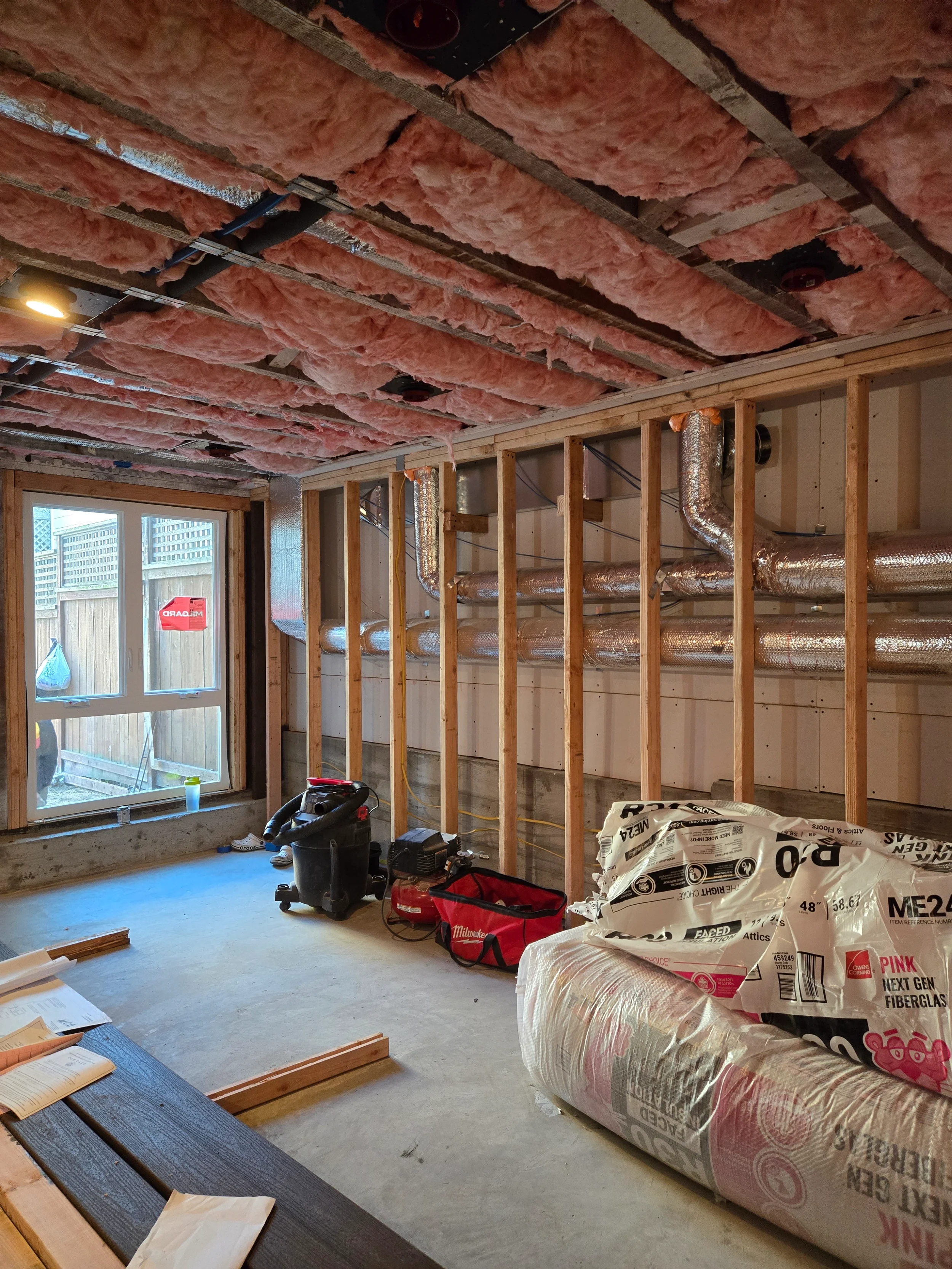 New stud wall with insulation during ground-floor conversion construction — San Francisco Bay Area general contractor
