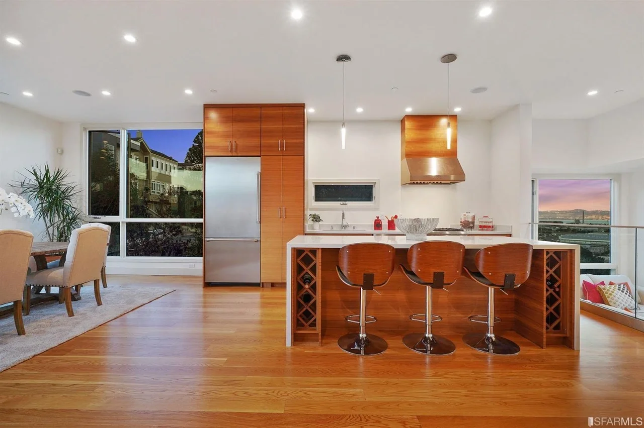 Kitchen addition with large island, bar stools, and pendant lighting — San Francisco Bay Area general contractor