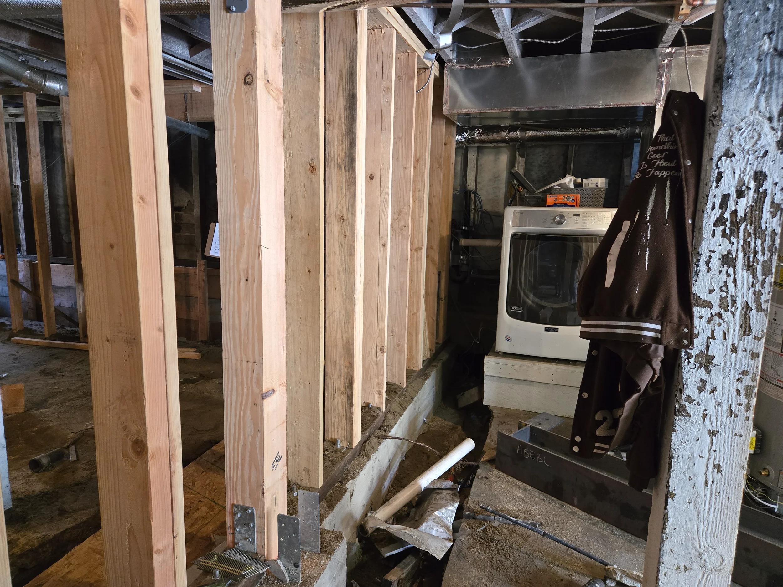 Crawlspace framing in progress with plumbing and structural members exposed — San Francisco Bay Area general contractor
