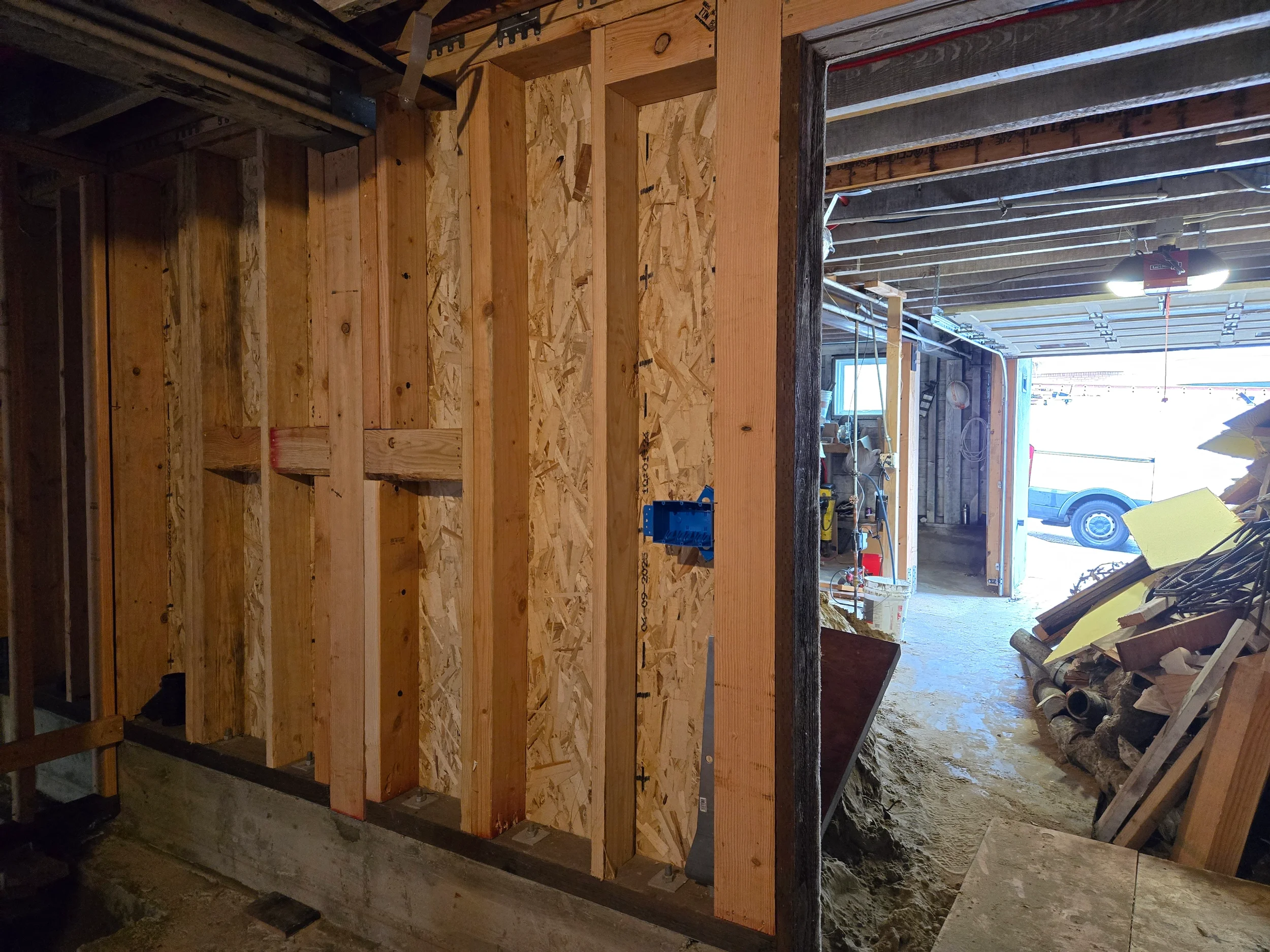 Stud wall framing with doorway opening for new ground-floor room layout — San Francisco Bay Area general contractor