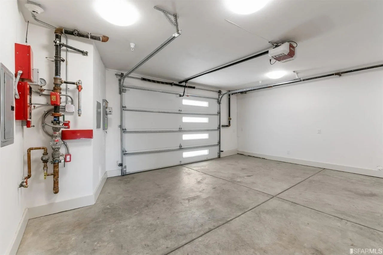Finished garage interior in single-family home addition with clean, bright lighting — San Francisco Bay Area general contractor