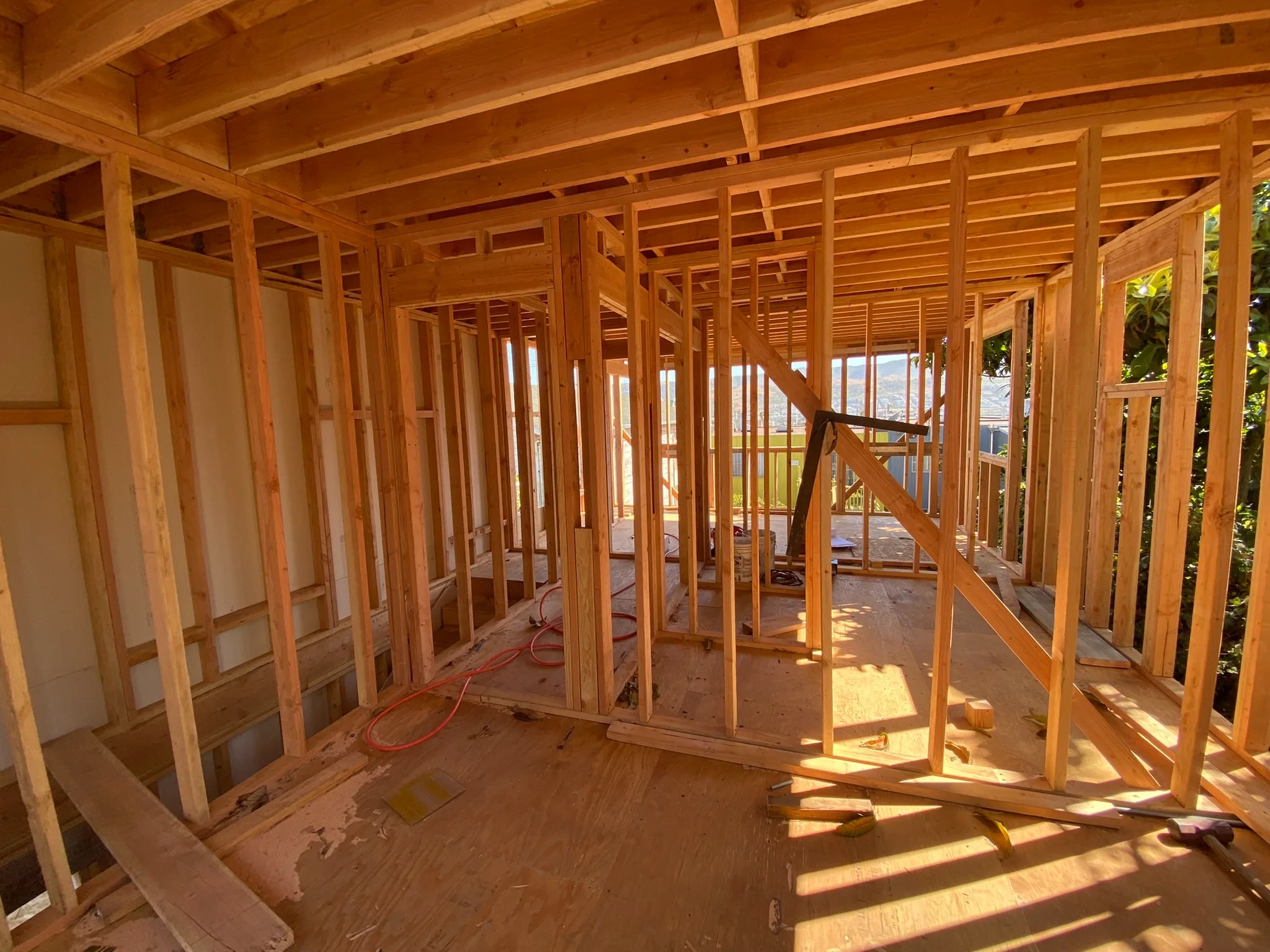 Construction framing in progress with exposed studs and structural layout — San Francisco Bay Area general contractor