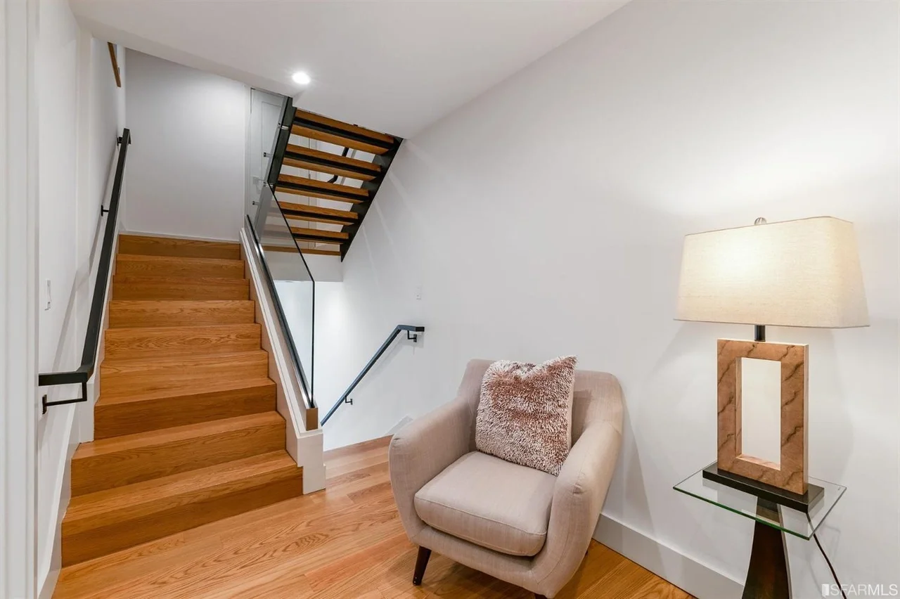 Open-riser staircase in vertical addition with wood treads and metal railing — San Francisco Bay Area general contractor