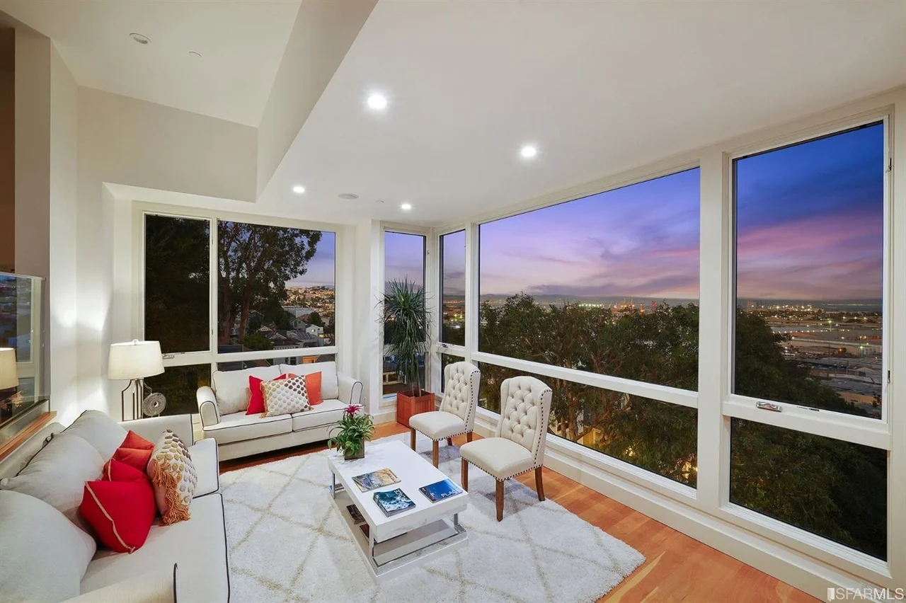 Living room with wall-to-wall windows and twilight view — San Francisco Bay Area general contractor