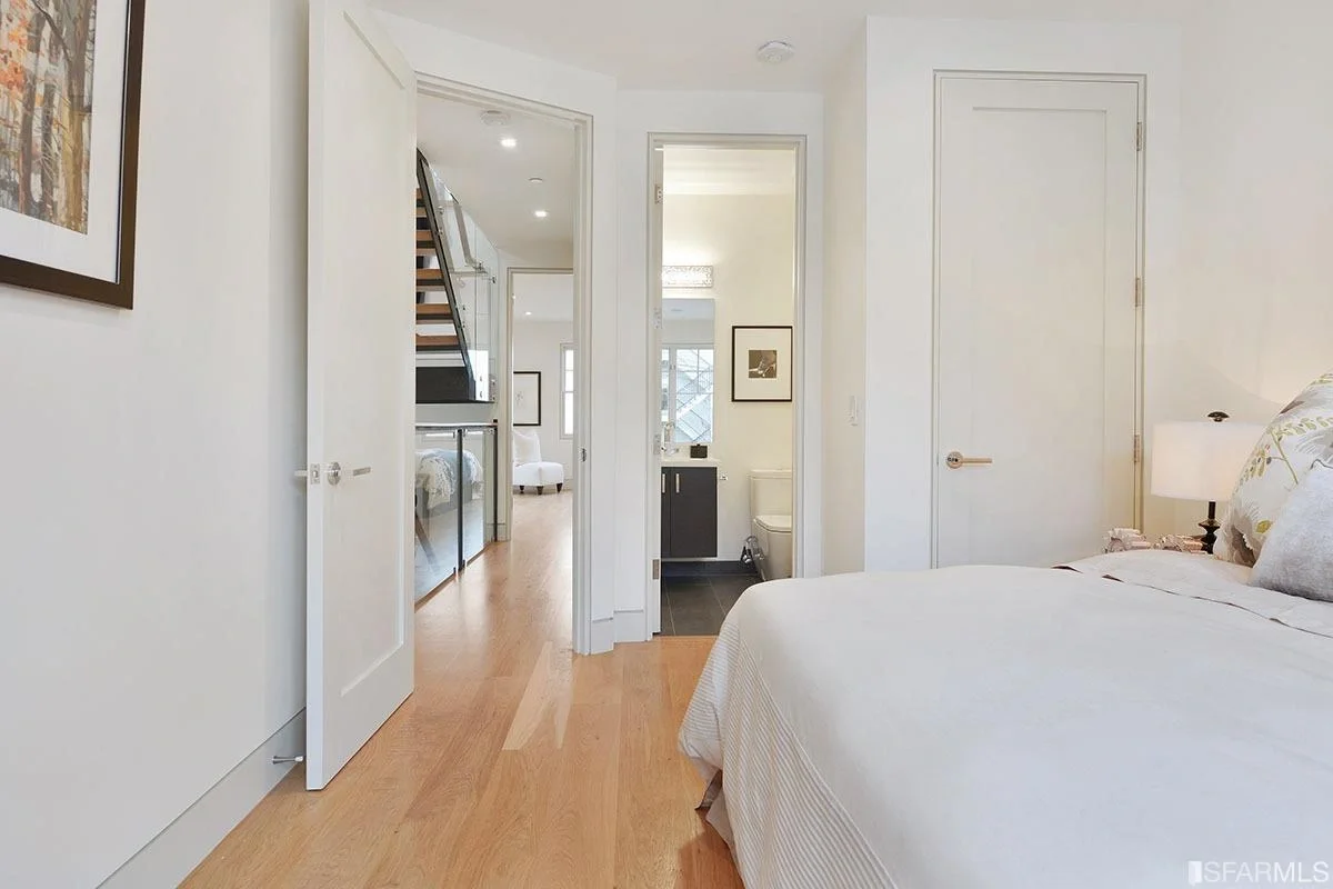 hallway with modern trim, white doors, and wide-plank flooring — San Francisco Bay Area general contractor