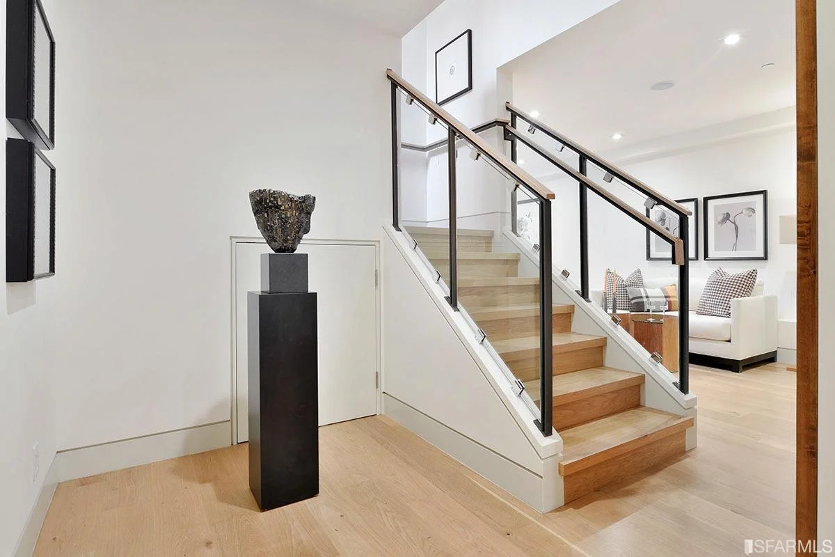 staircase leading to upper level with iron railing and wood treads — San Francisco Bay Area general contractor