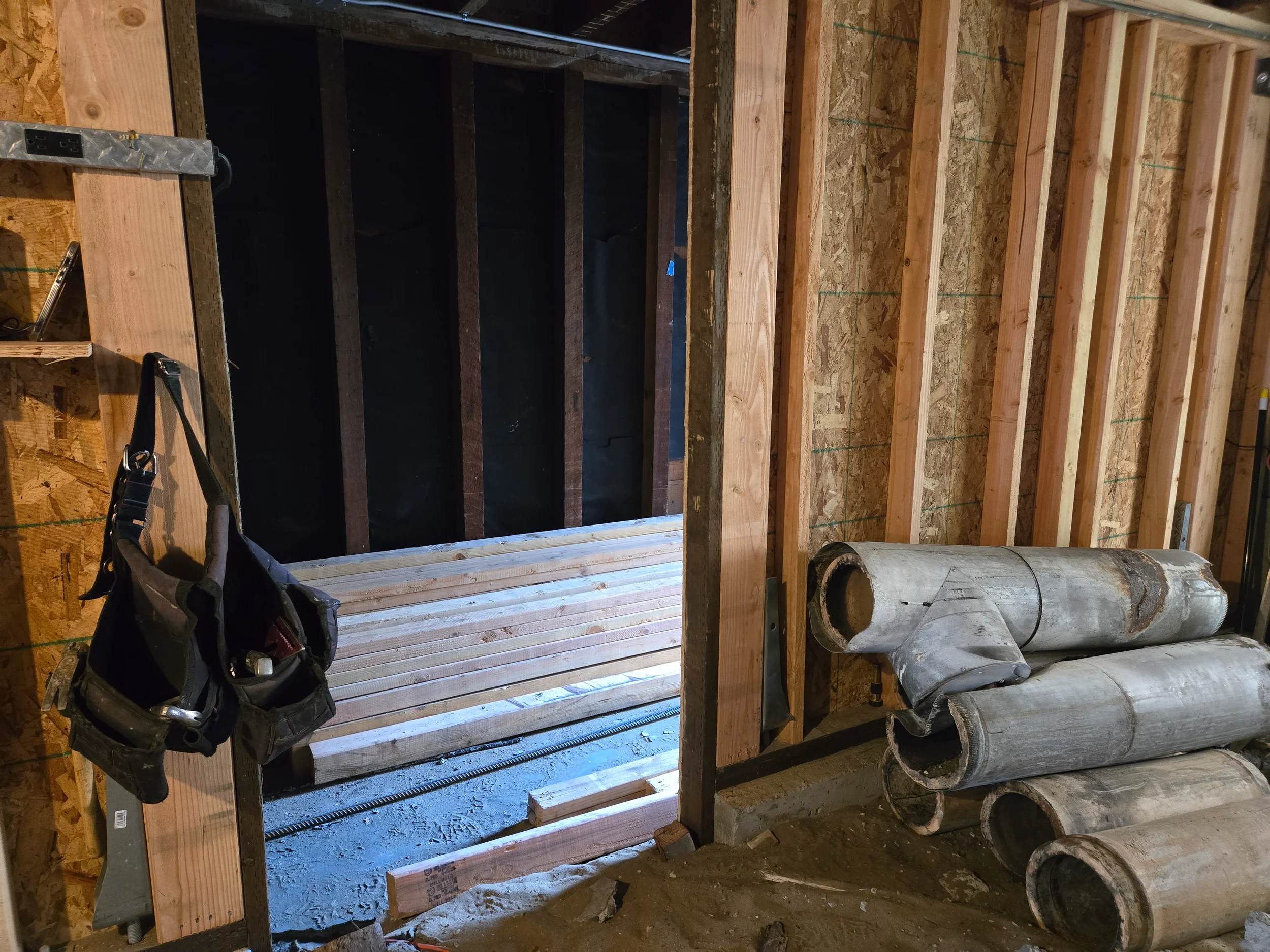 Crawlspace entry area during ground-floor conversion with framing and access opening — San Francisco Bay Area general contractor