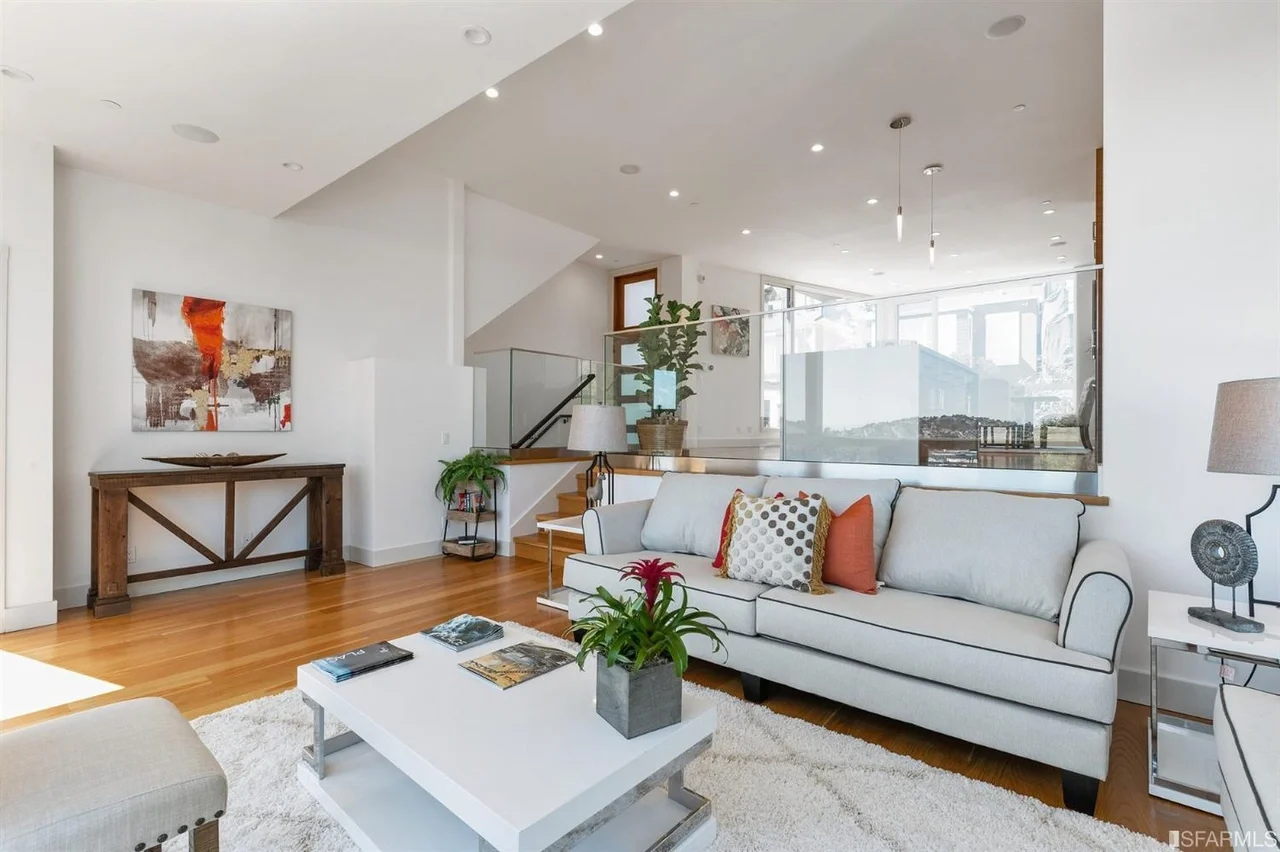 Contemporary living space with oversized windows and hardwood flooring in home addition — San Francisco Bay Area general contractor