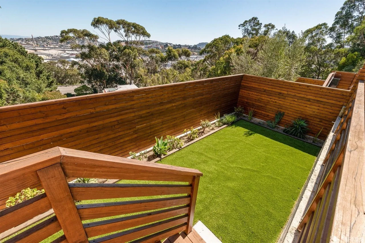 New backyard lawn and fencing installed with single-family home addition — San Francisco Bay Area general contractor