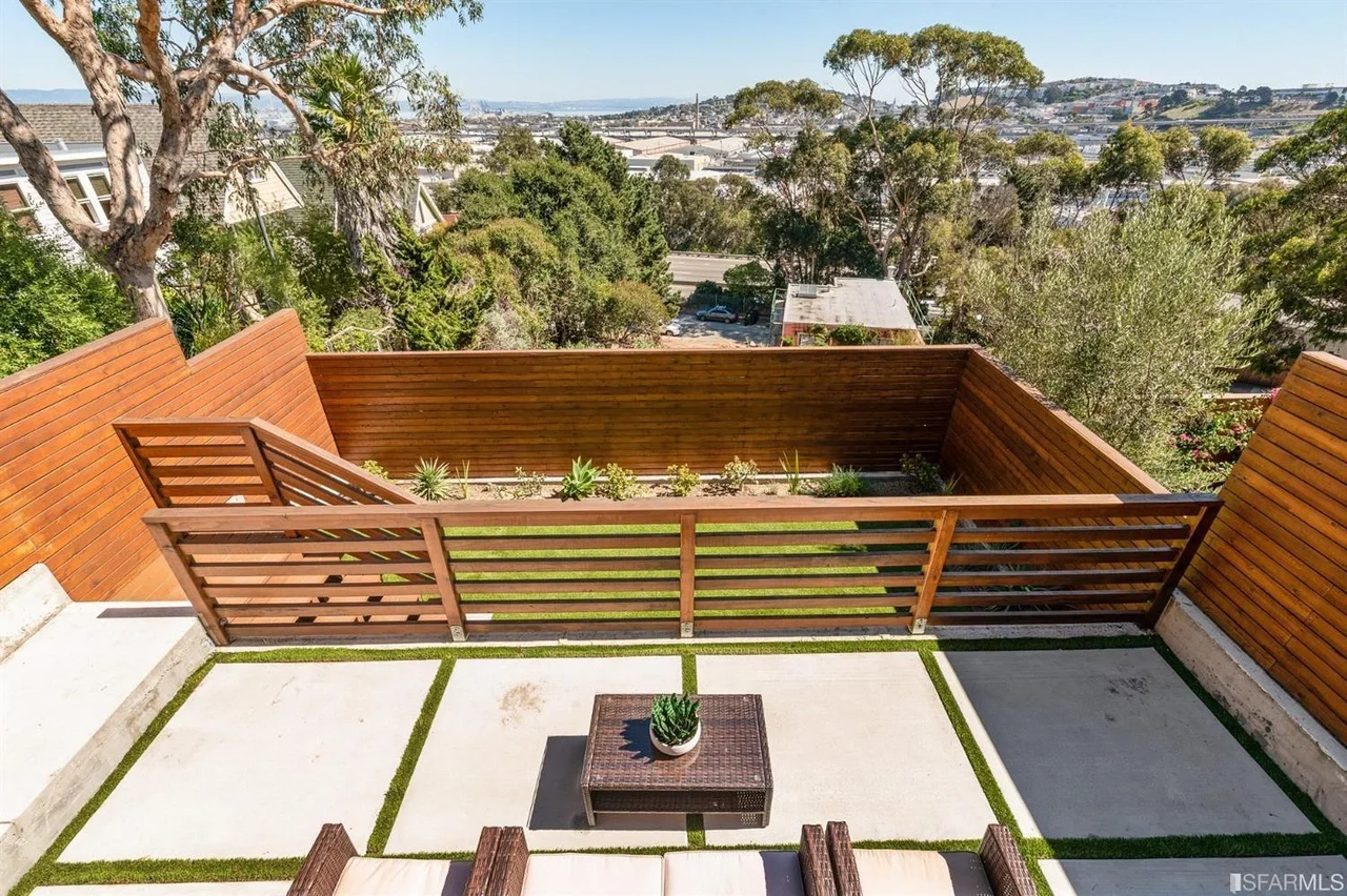 Backyard deck and patio in home addition with wood railing and outdoor seating — San Francisco Bay Area general contractor