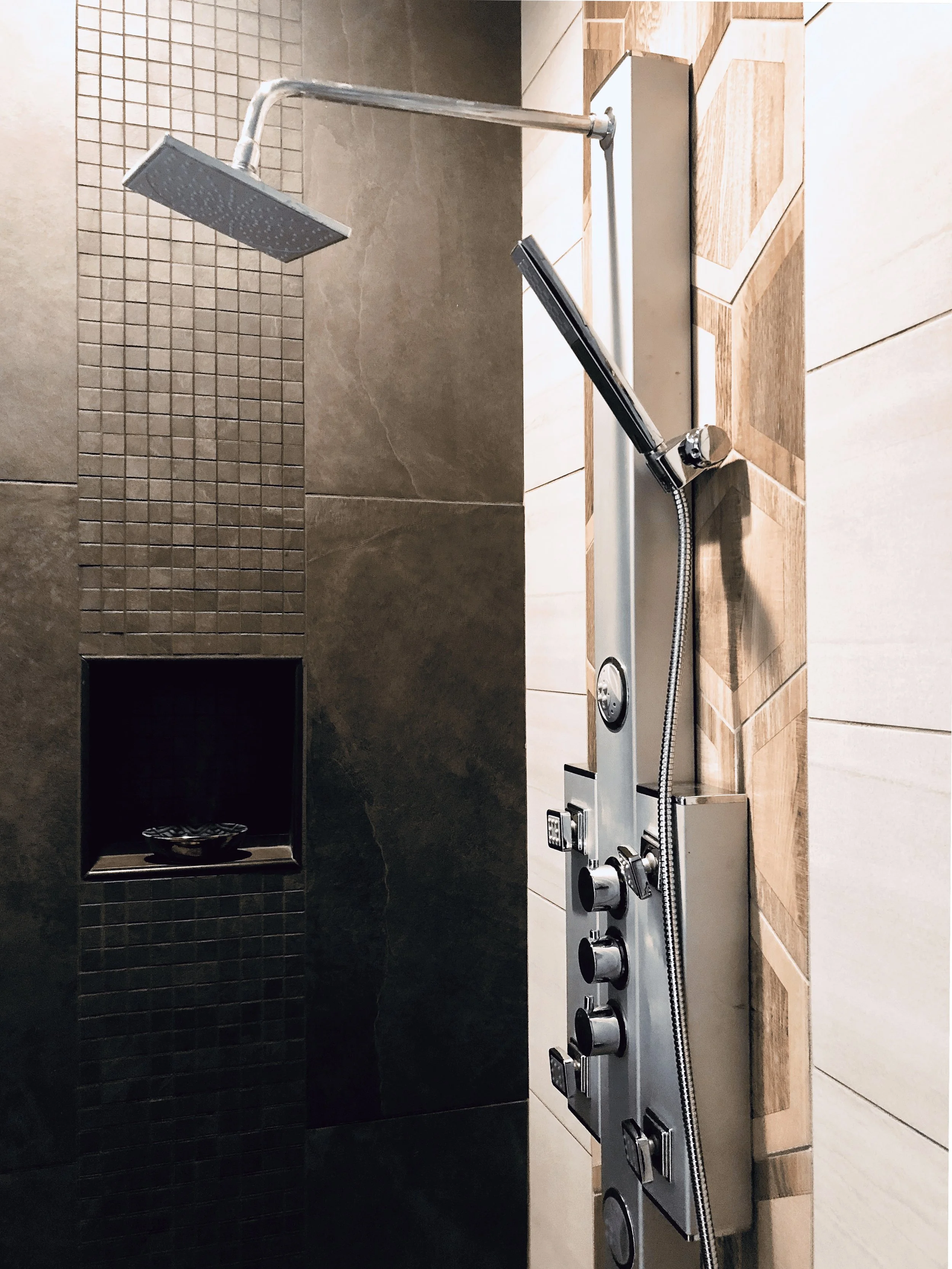 Luxury multi-function shower panel with rain head and dark mosaic tile wall alongside hexagon wood-look accent tile, Buckhead Atlanta, GA private residence, interior design by Luxe Style Studio