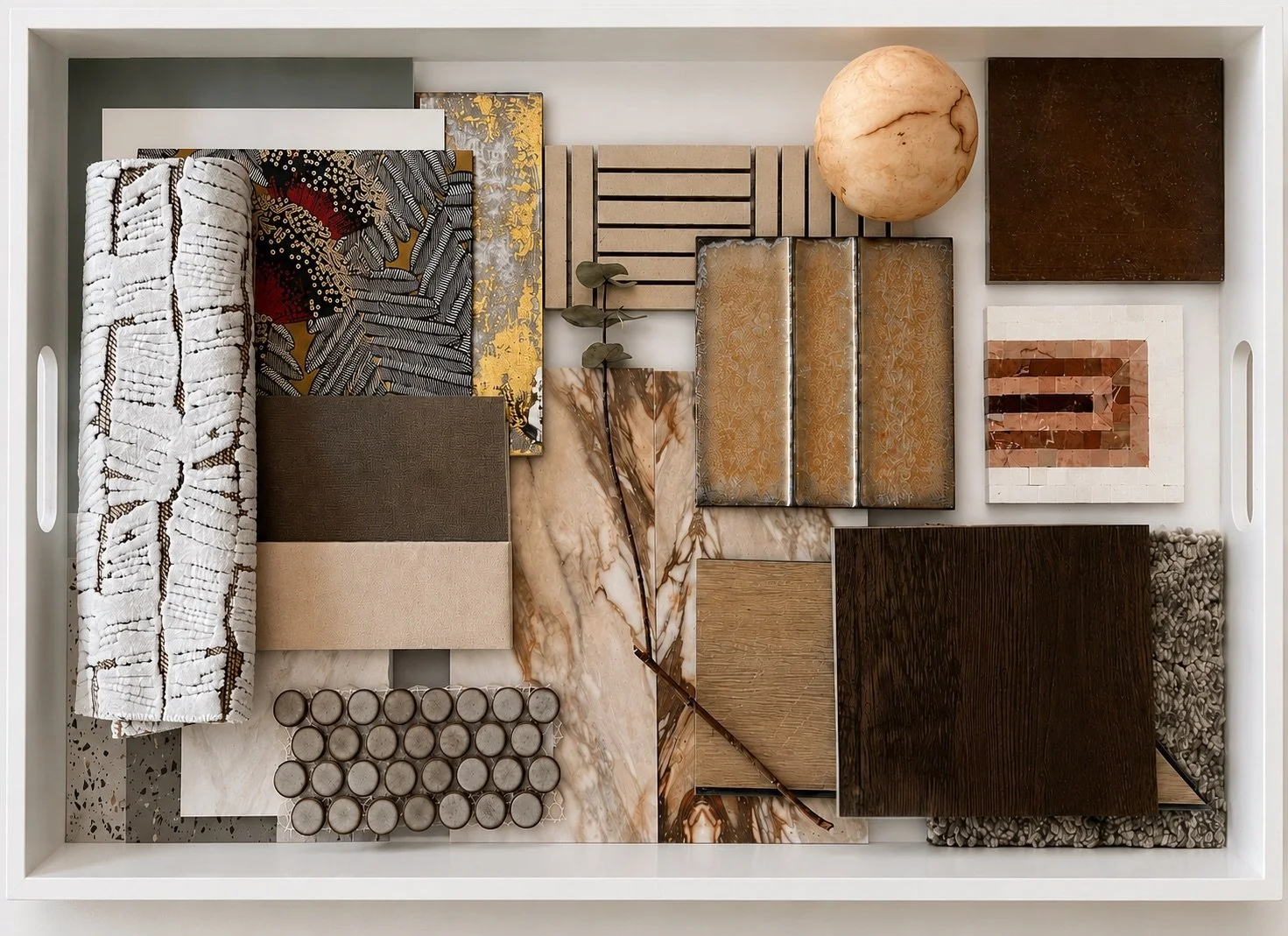 Interior design material board with fabric, tile, wood, stone, and metal finish samples arranged in a white tray, designed by Luxe Style Studio