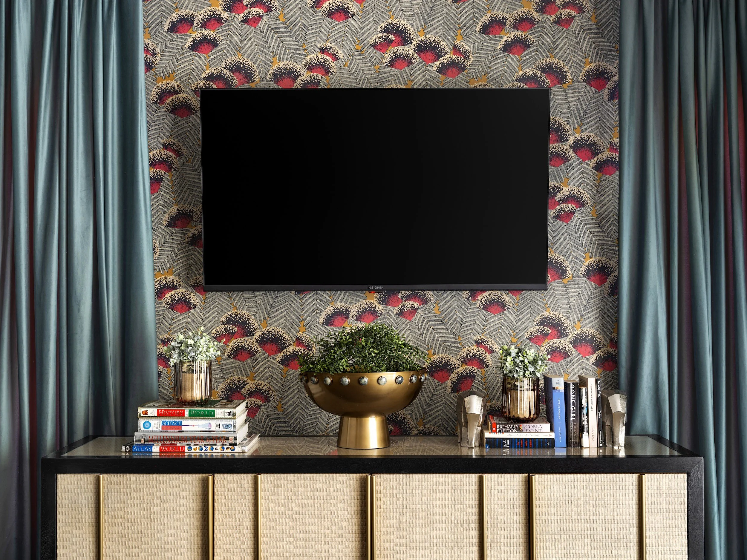 Peacock-feather wallpaper, cane sideboard, and teal velvet drapery in the music lounge, designed by Luxe Style Studio