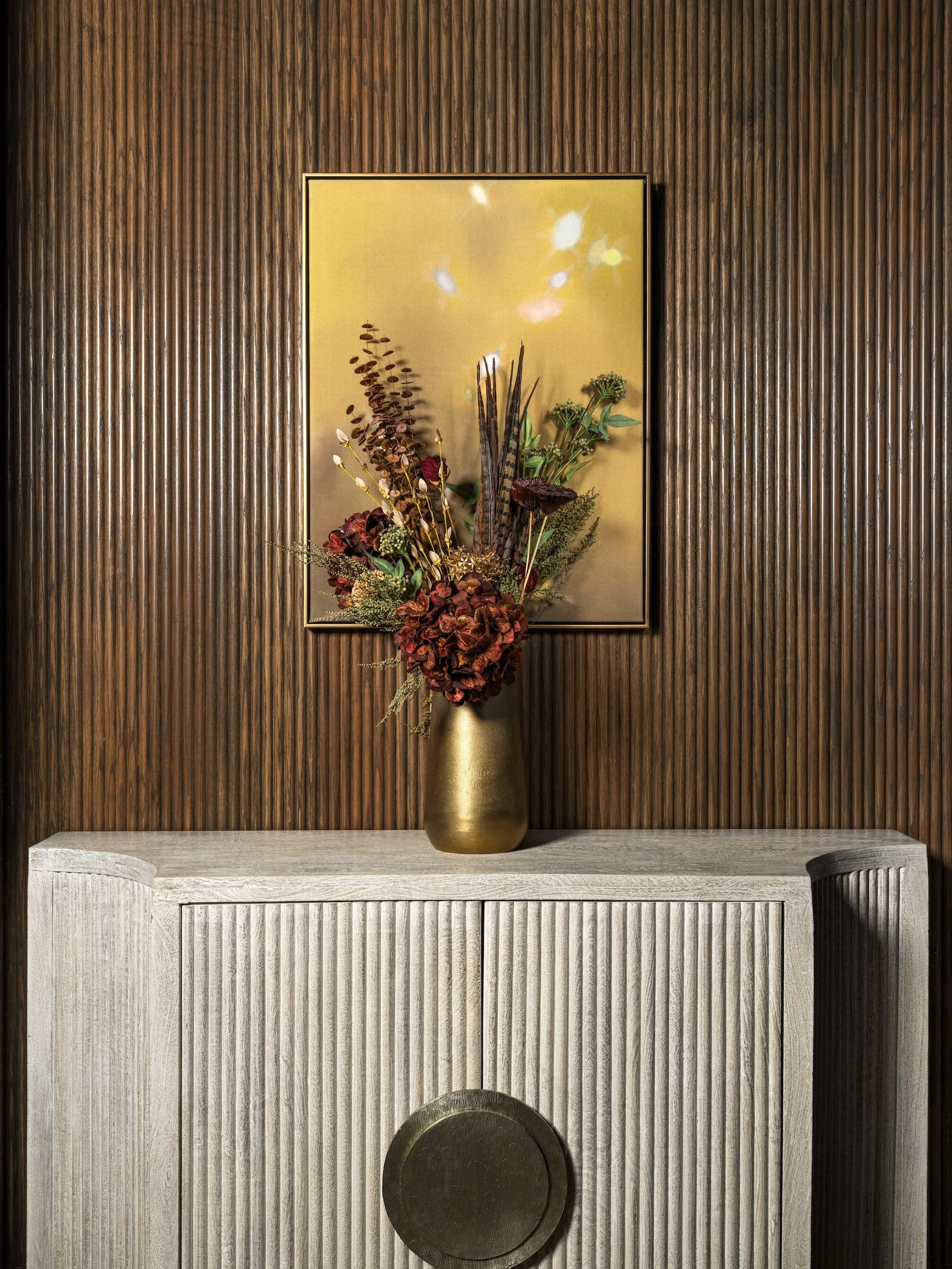 Fluted oak theater console against a dark vertical-slat wall, designed by Luxe Style Studio