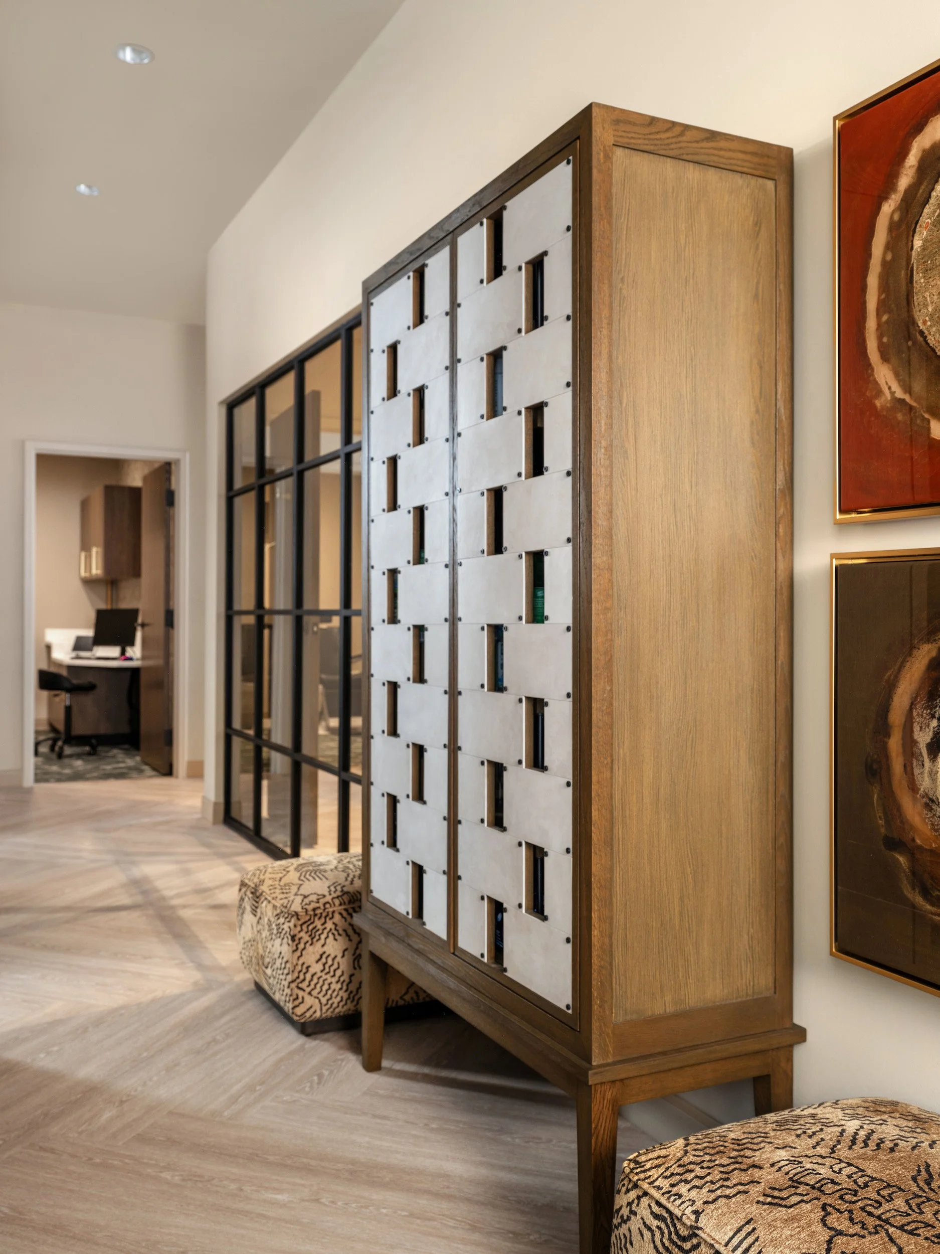 Custom woven leather and oak cabinet creating separation within Windsor Eye Care, designed by Luxe Style Studio