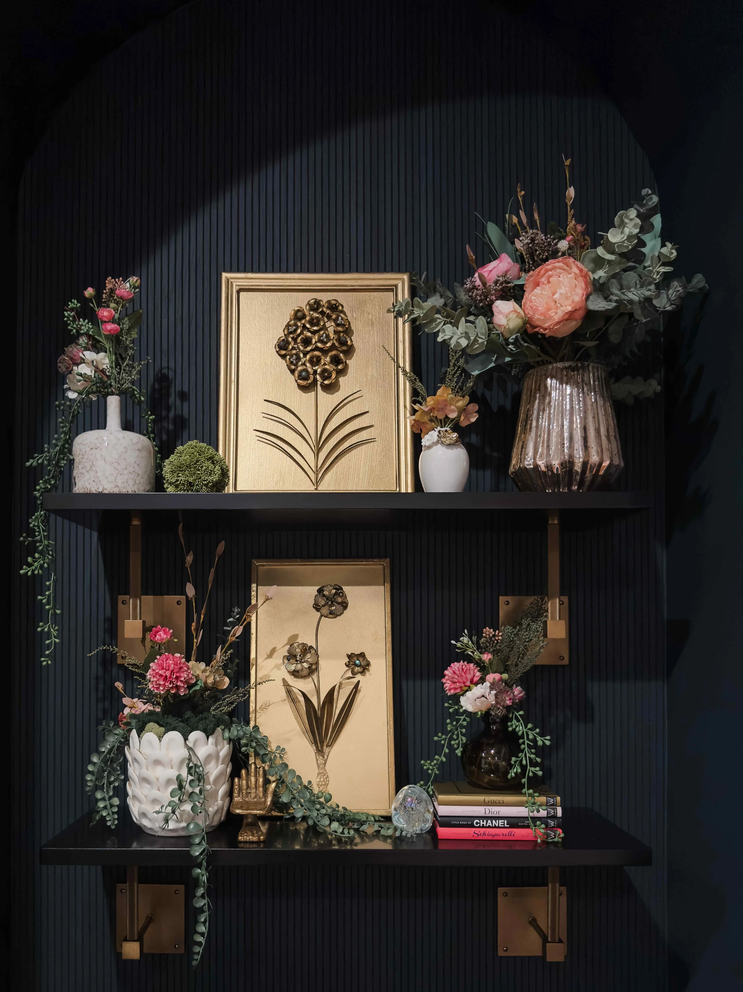 East Cobb living room arched niche shelving styled with gold floral artwork, mercury glass vases, cascading greenery, and designer books, East Cobb, GA private residence, interior design by Luxe Style Studio