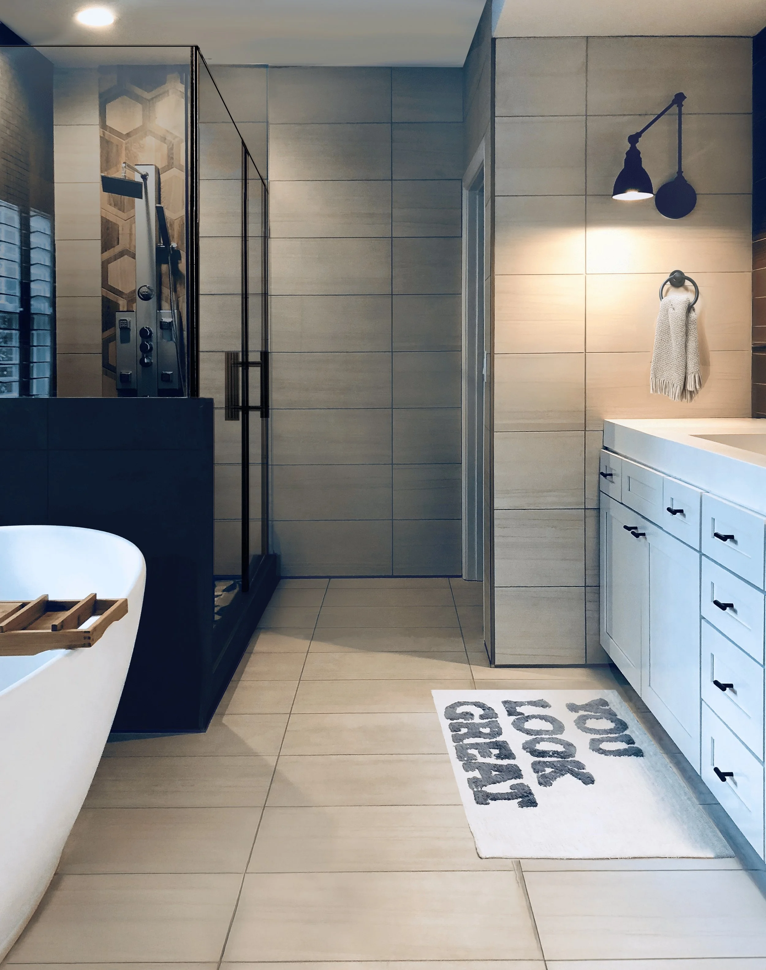 Primary bathroom with freestanding soaking tub, black-frame glass shower enclosure, white vanity, and large-format tile floor, Buckhead Atlanta, GA private residence, interior design by Luxe Style Studio