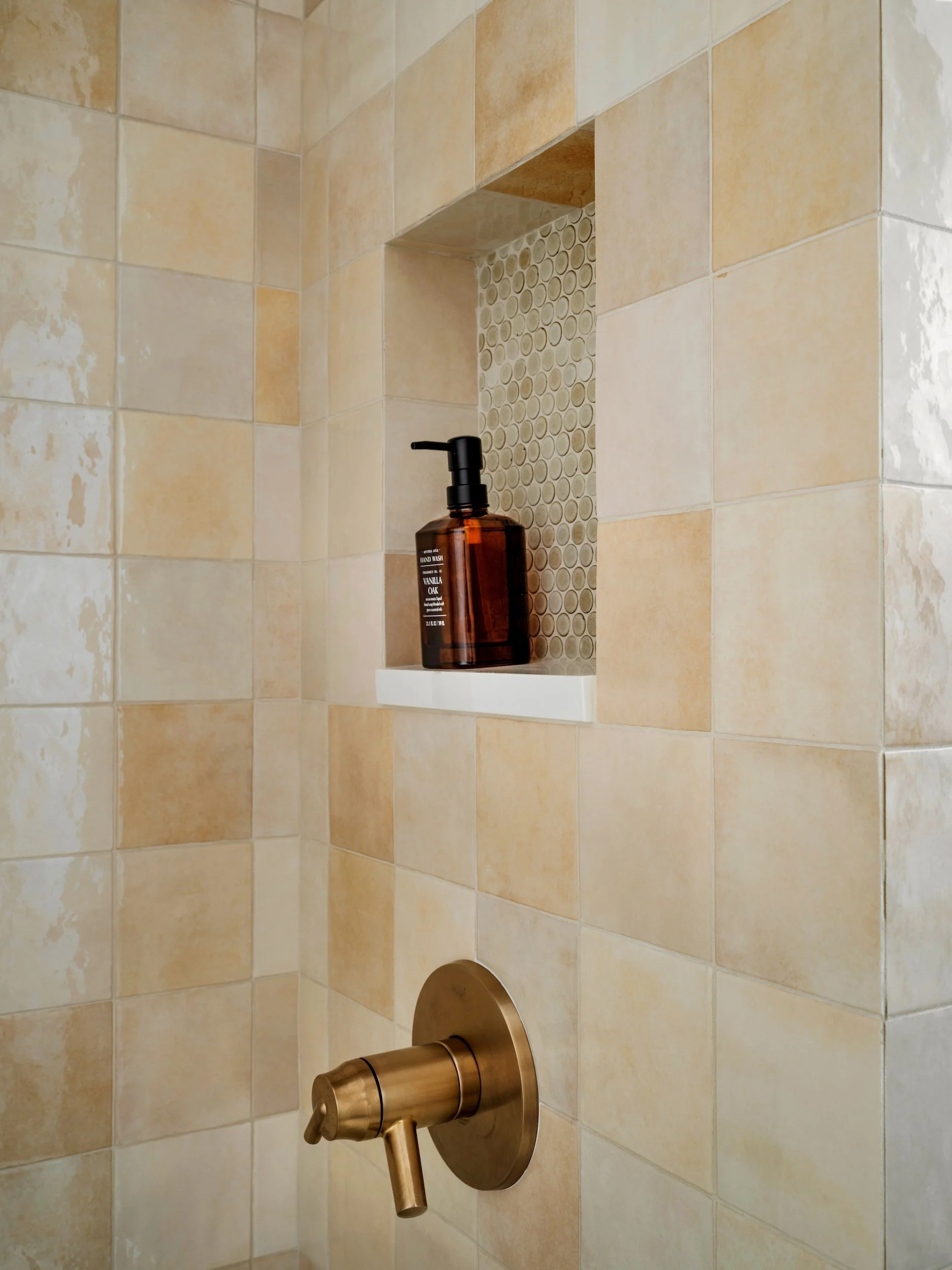 Shower niche detail with warm cream zellige field tile, penny tile niche accent, and brushed brass shower valve, Atlanta, GA private residence, interior design by Luxe Style Studio