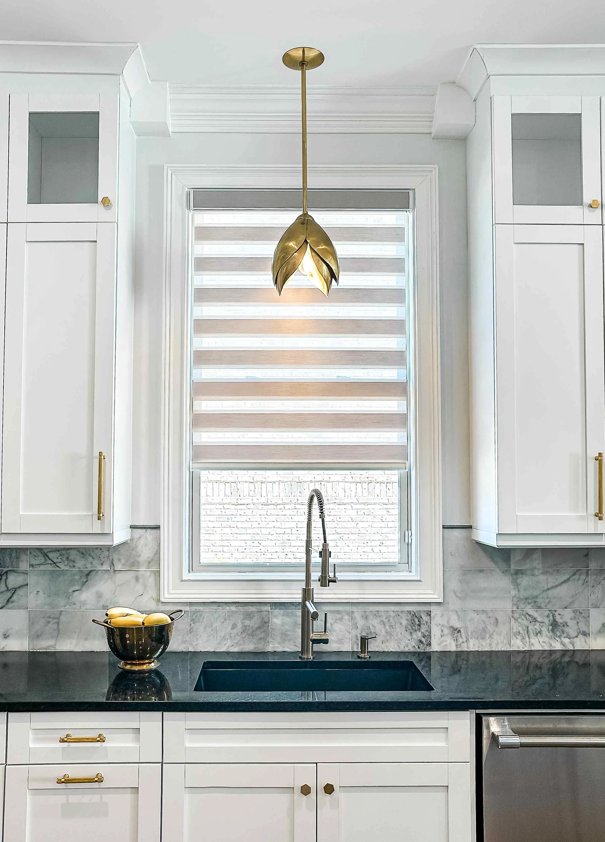 East Cobb luxury kitchen with sculptural brass magnolia pendant light over farmhouse sink, white shaker cabinets, and marble tile backsplash, East Cobb, GA private residence, interior design by Luxe Style Studio